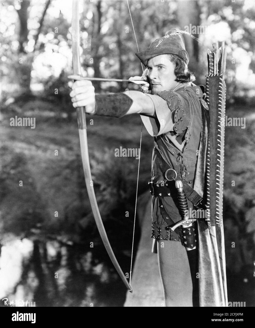 ERROL FLYNN with bow and arrow in THE ADVENTURES OF ROBIN HOOD 1938 directors MICHAEL CURTIZ and WILLIAM KEIGHLEY music Erich Wolfgang Korngold Warner Bros. Stock Photo