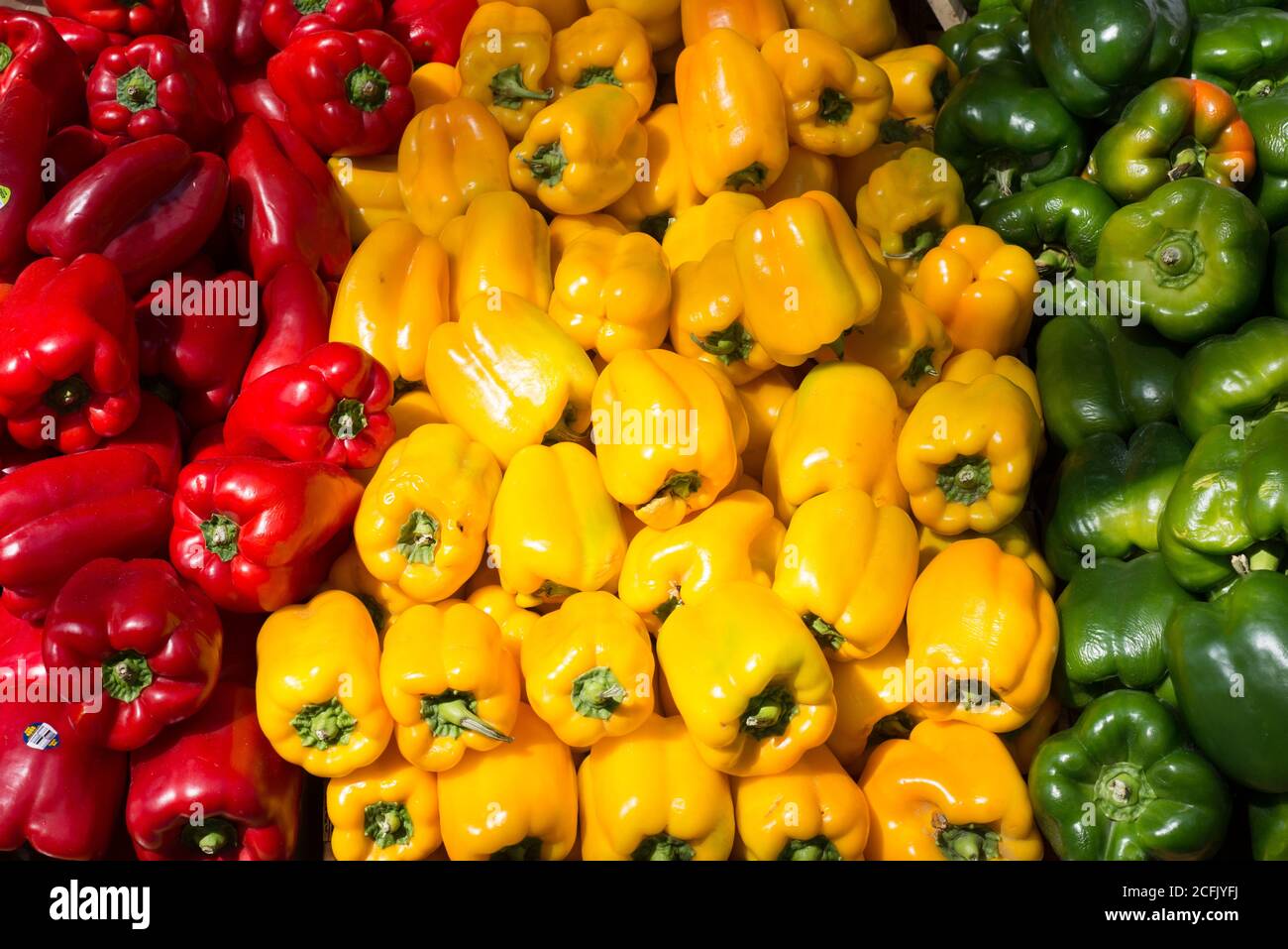 Red, Yellow and green bell peppers for sale at an outdoor food market ...
