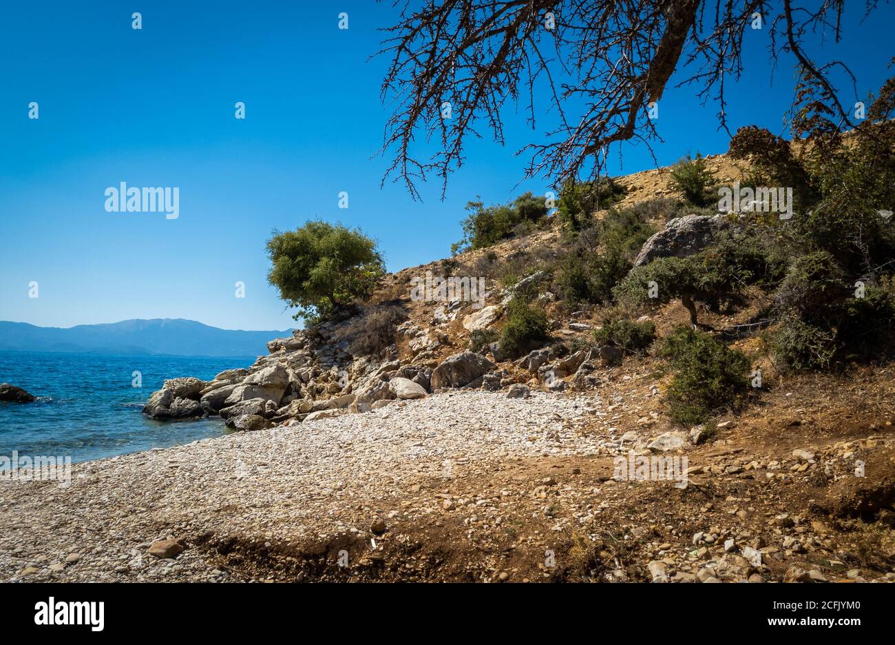 A unspoilt deserted beach on the outskirt of the seaside town Mytikas on a beautiful clear sunny summer day. Stock Photo