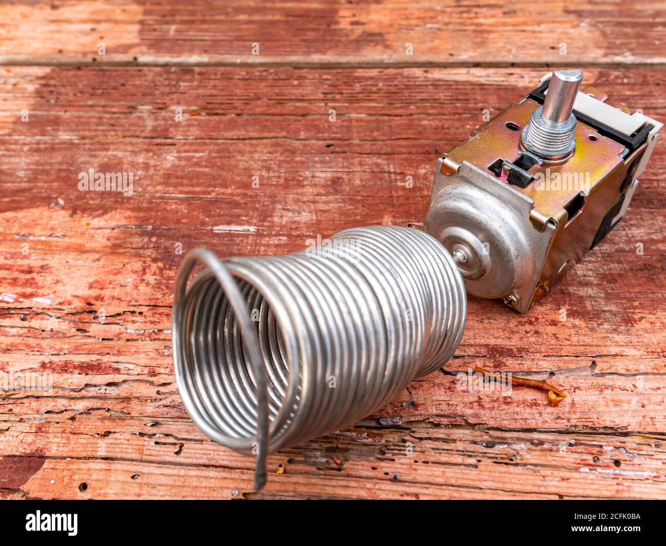 Thermostat is a spare part for refrigerator repair. Stock Photo