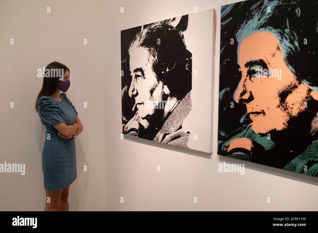 A visitor wearing face mask due to the COVID-19 coronavirus pandemic views painting by Andy Warhol depicting the fourth Prime Minister of Israel Golda Meir displayed at the Modern Art Wing of the Israel Museum in West Jerusalem Israel Stock Photo