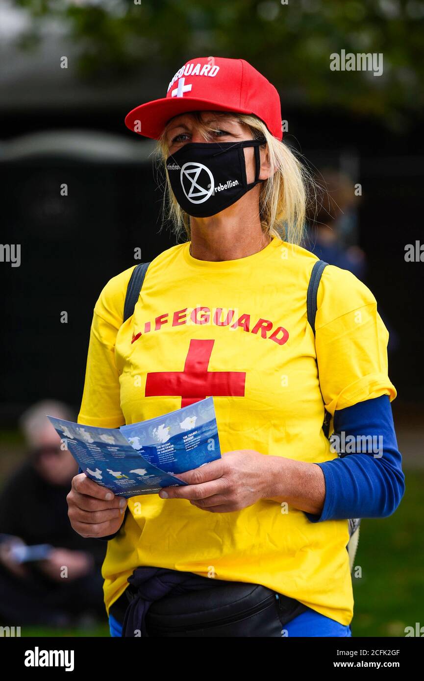 London, UK.  6 September 2020.  An activist from Extinction Rebellion (XR) dressed as a Life Guard during a 'Flood Alert' protest on the shore of the River Thames near Gabriel's Wharf on the South Bank to highlight the effects of climate change on rising sea levels.  Credit: Stephen Chung / Alamy Live News Stock Photo