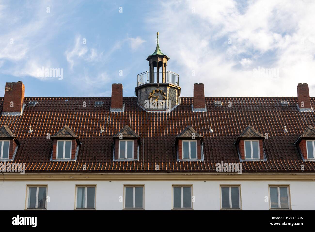 Rooftop and clockl tower of historical school building in Wolfsburg Stock Photo