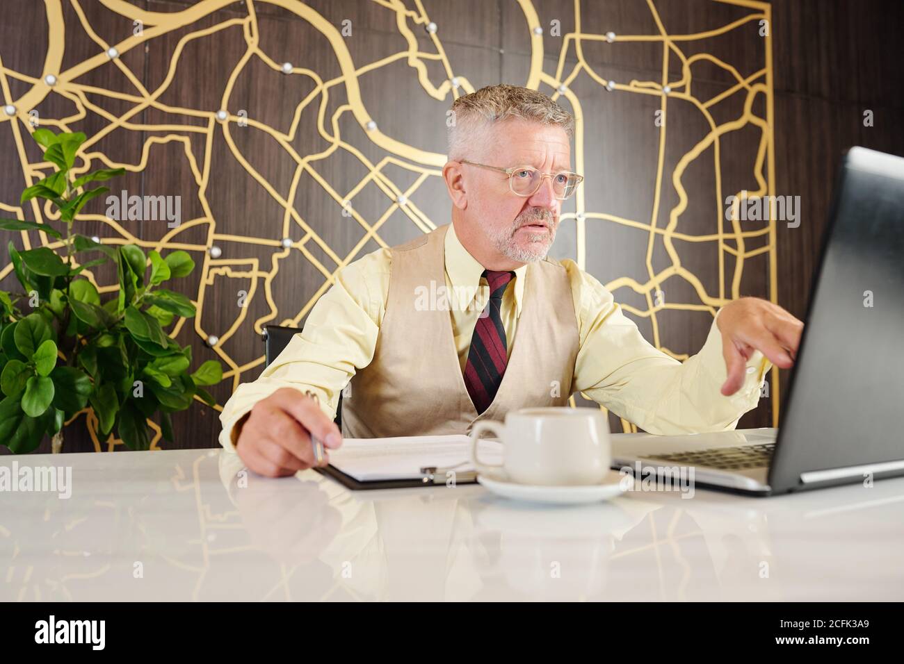 Serious businessman working on laptop Stock Photo