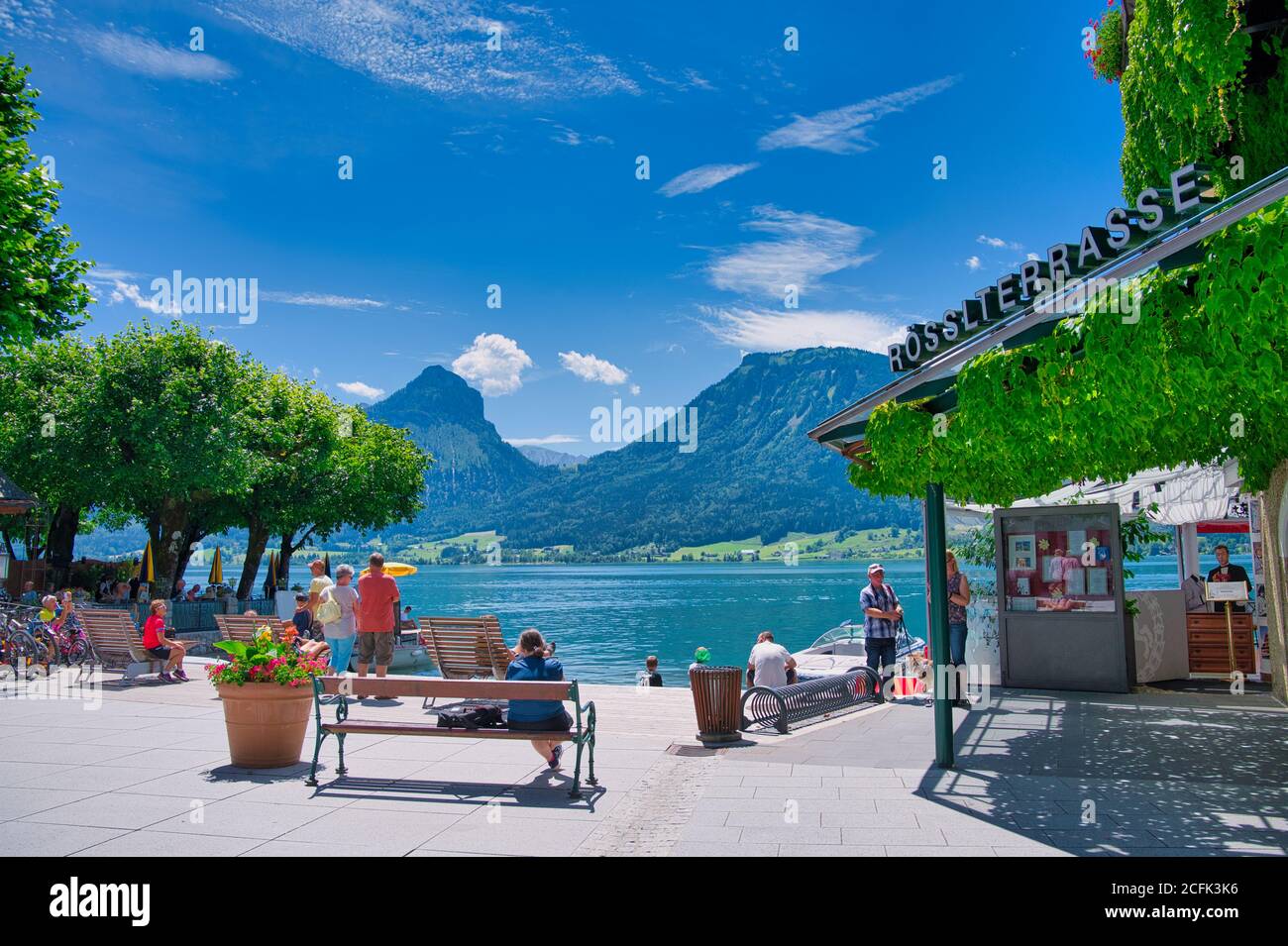St. Wolfgang, Austria - July 09,2020: people at the lake Wolfgang with view to the famous terrace of the legendary White Horse Inn (Weisses Roessl) Stock Photo