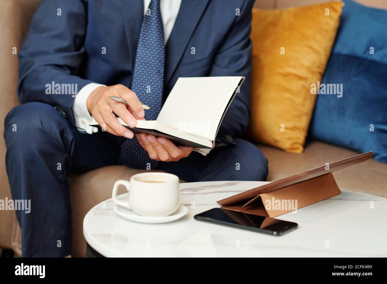 Businessman checking planner Stock Photo