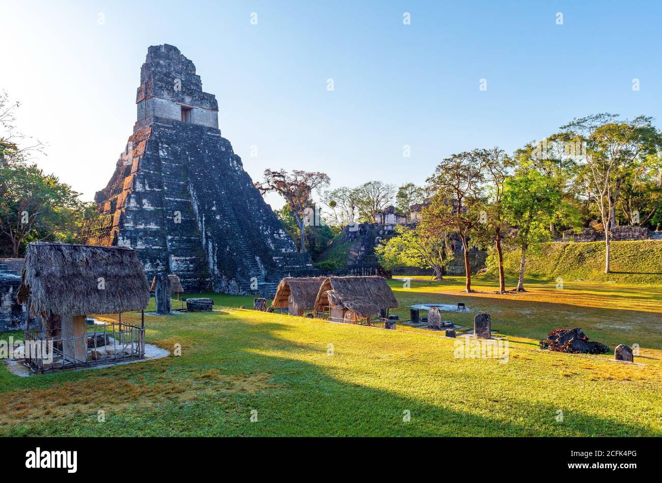 Main Square of the Mayan archaeological site of Tikal with Temple I or Temple of the Great Jaguar Pyramid on the left, Peten Rainforest, Guatemala. Stock Photo