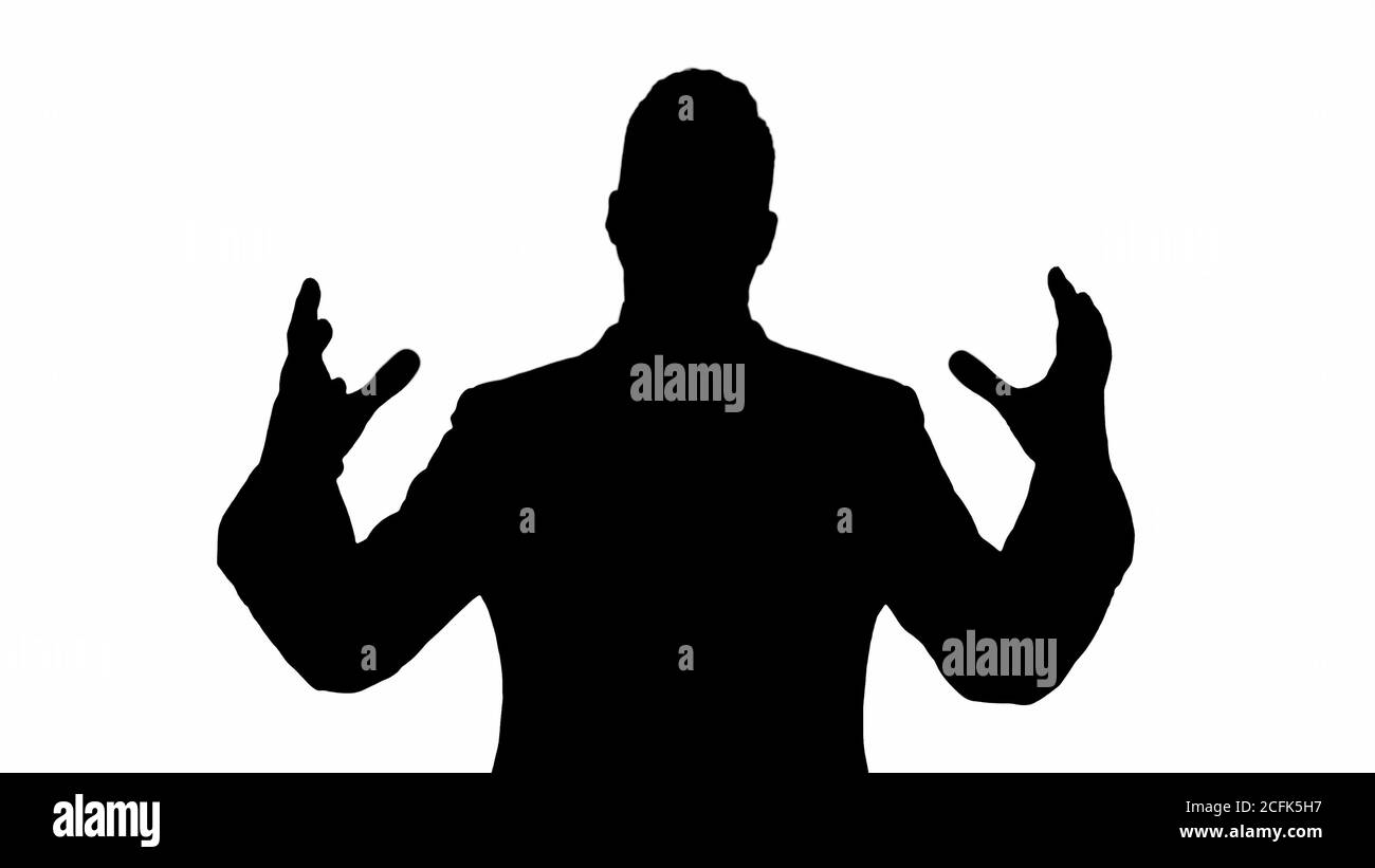 Silhouette Man in formal clothes speaking to camera doing hand gestures in a very expressive and positive way. Stock Photo