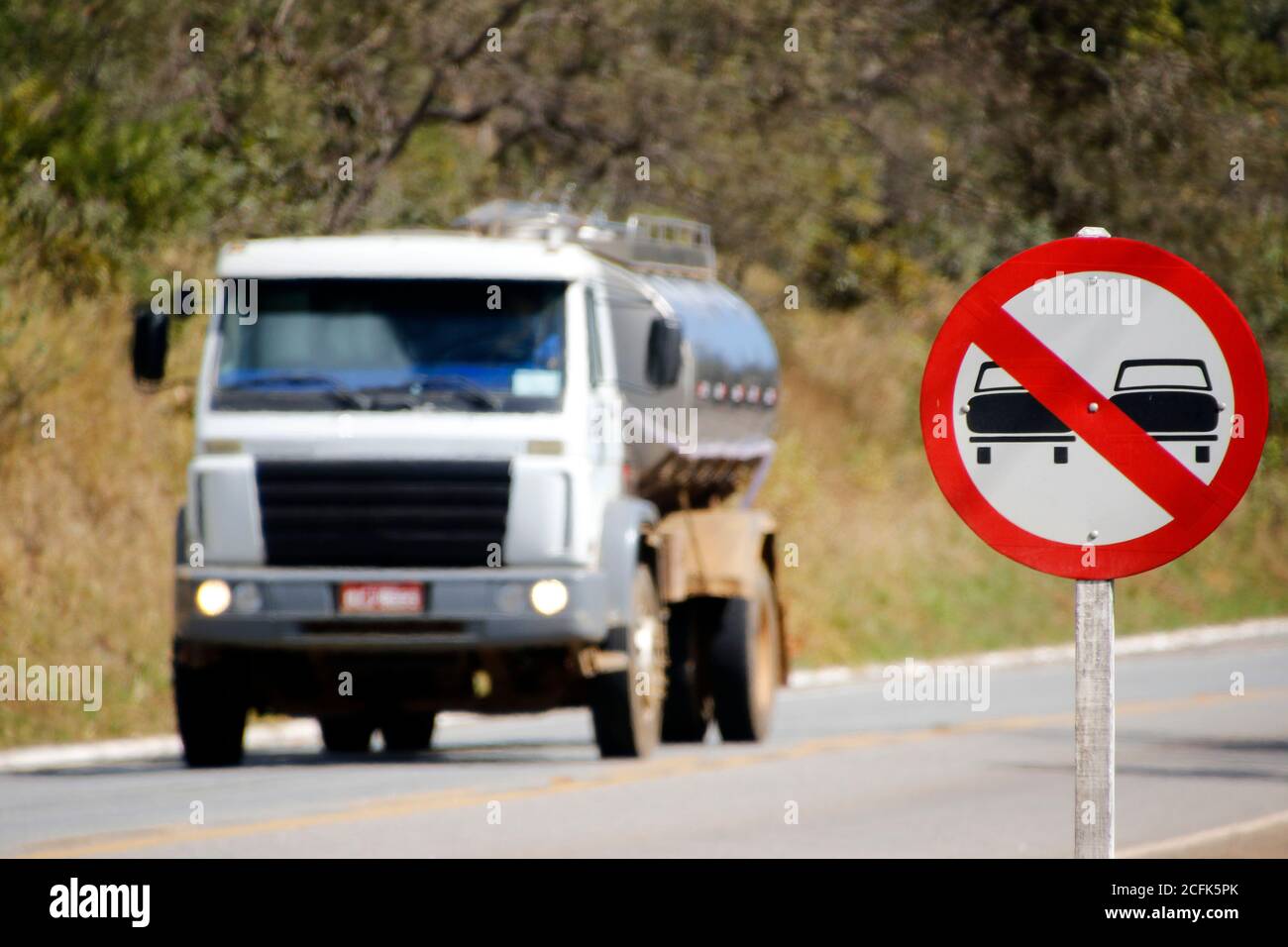 Minas Gerais / Brazil - 2019-06-23: road tanker and road sign indicating prohibited overtaking area Stock Photo