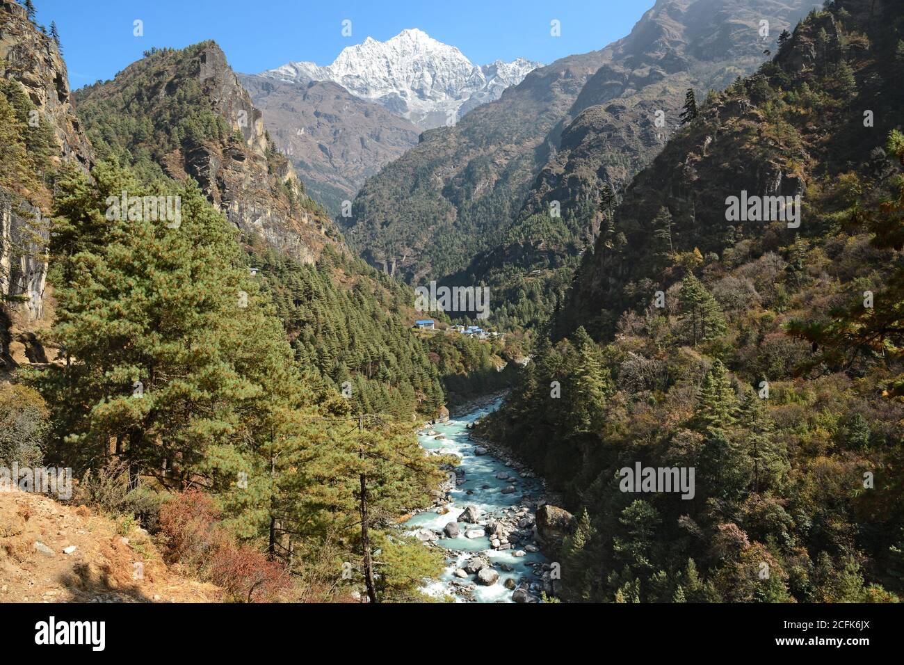 The first view of Thamserku while hiking along the Dudh Koshi river in Nepal. Stock Photo