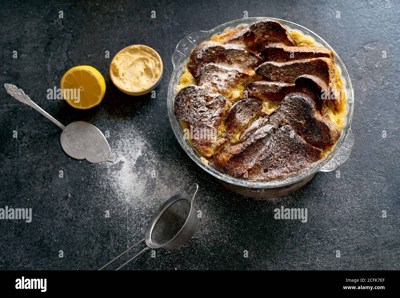 Top View Of Traditional Bread Pudding With Custard Served With Aromatic Orange Zest Butter And Powdered Sugar On Dark Background Stock Photo Alamy