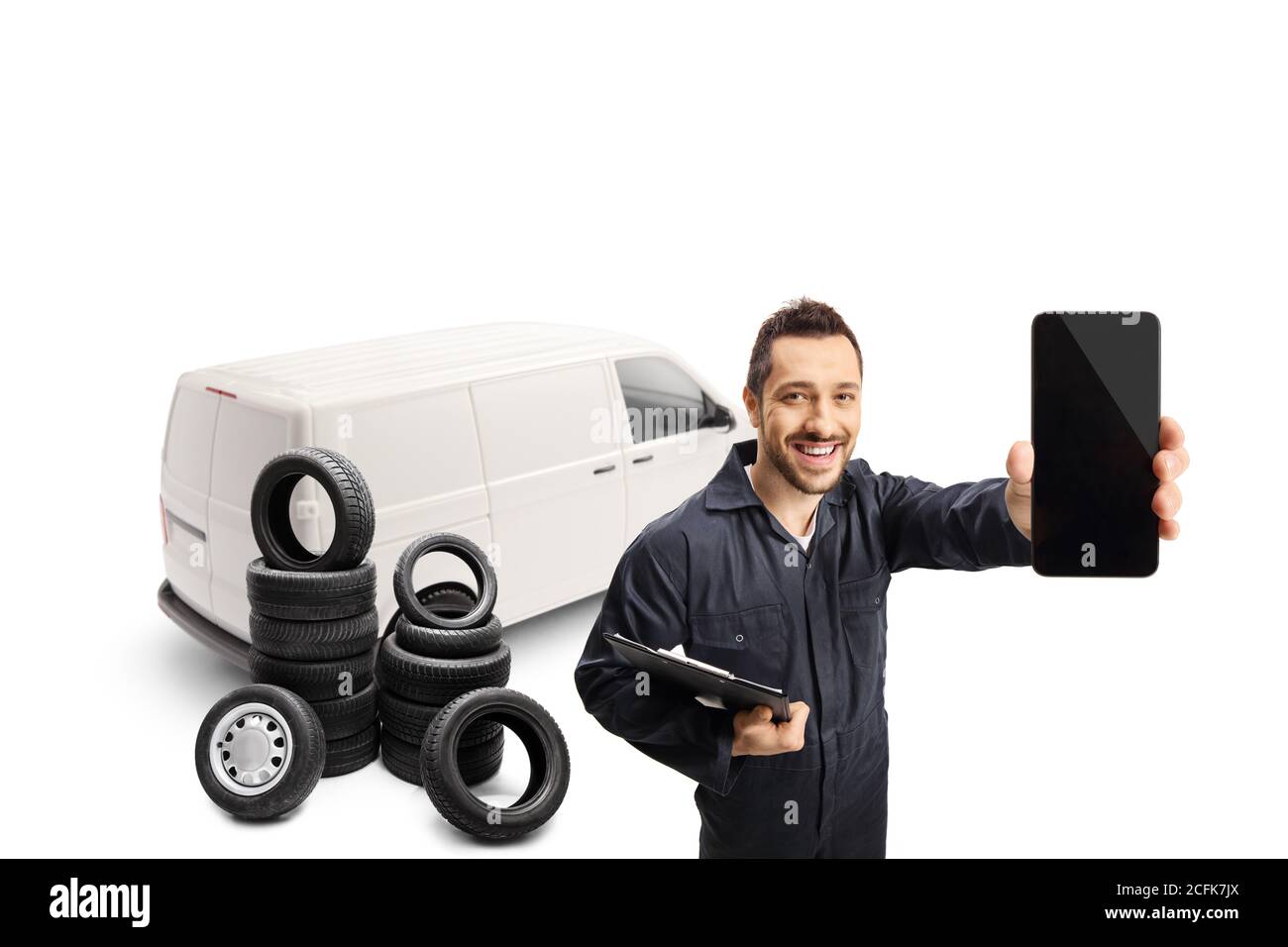 Auto mechanic with a white van holding a mobile phone isolated on white background Stock Photo