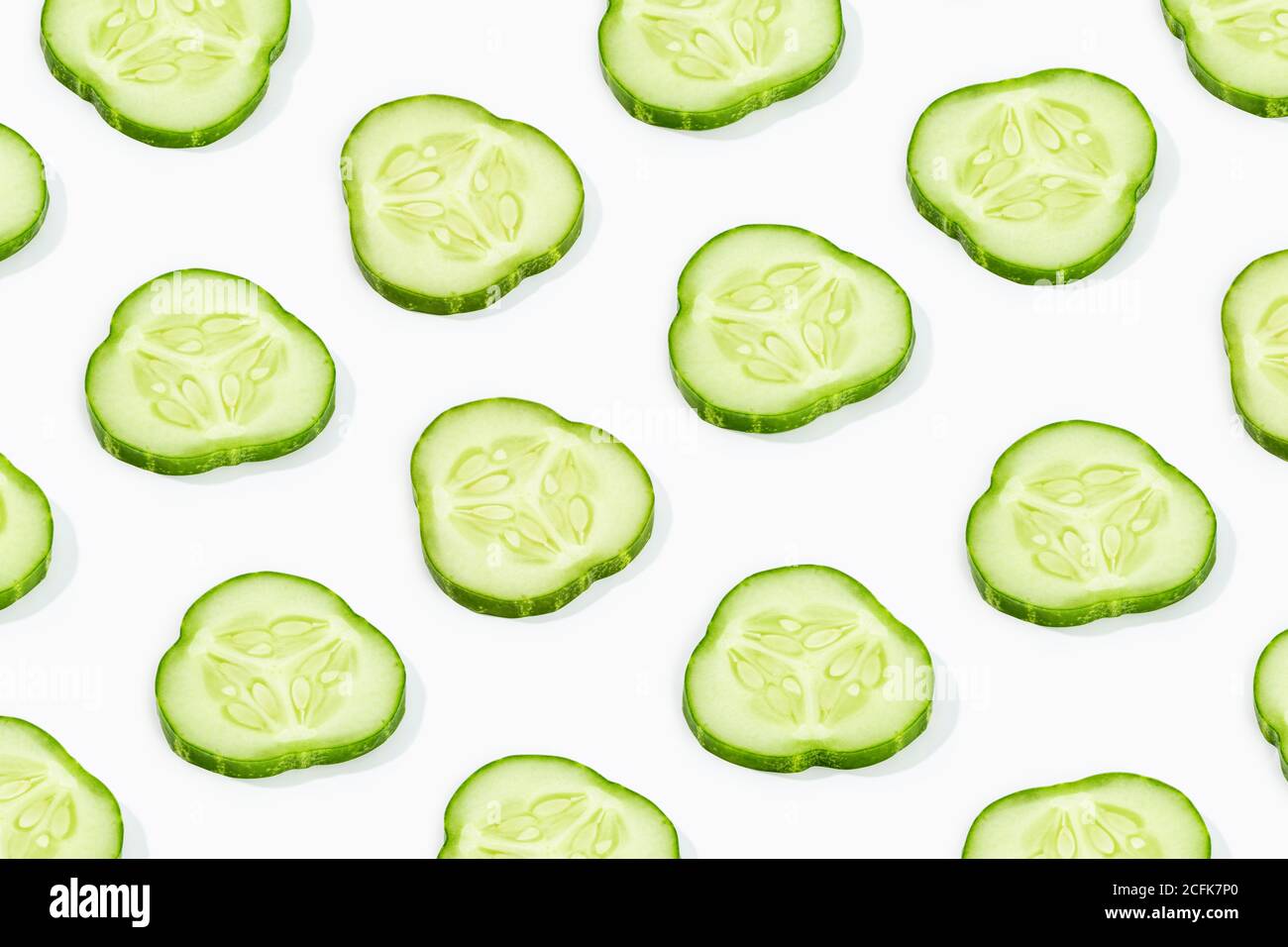 Cucumber slice pattern isolated on white background. Cucumis sativus backdrop Stock Photo