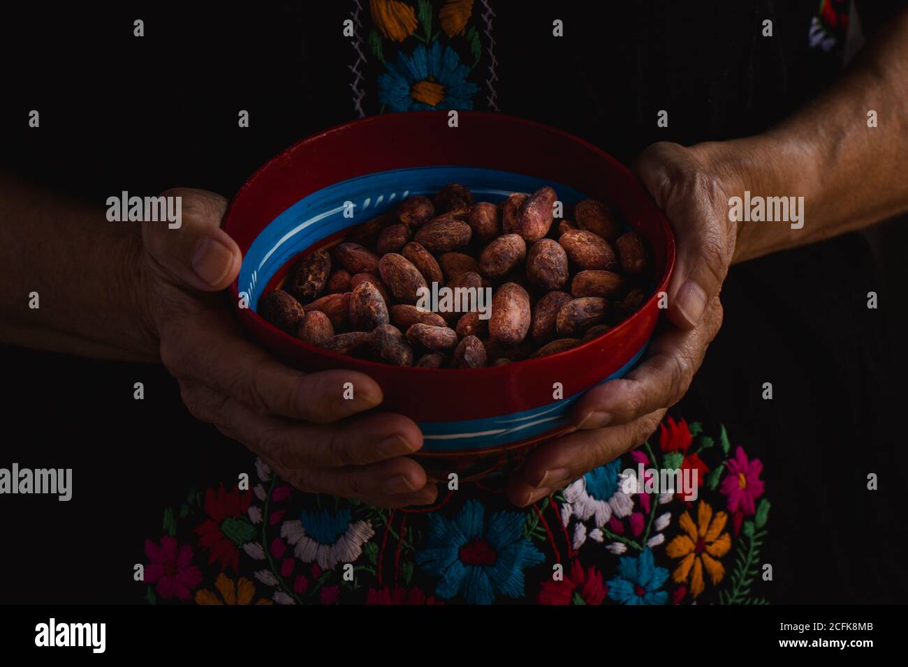 Cacao beans on a traditional colorful bowl from Oaxaca, Mexico Stock Photo