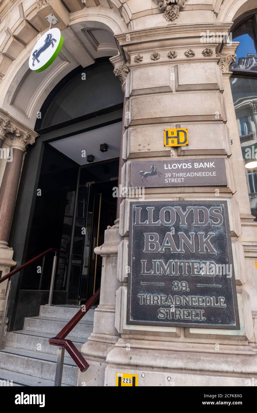 A branch of Lloyds Bank situated on Threadneedle Street, the City of London, with a old name plate by the entrance. Stock Photo