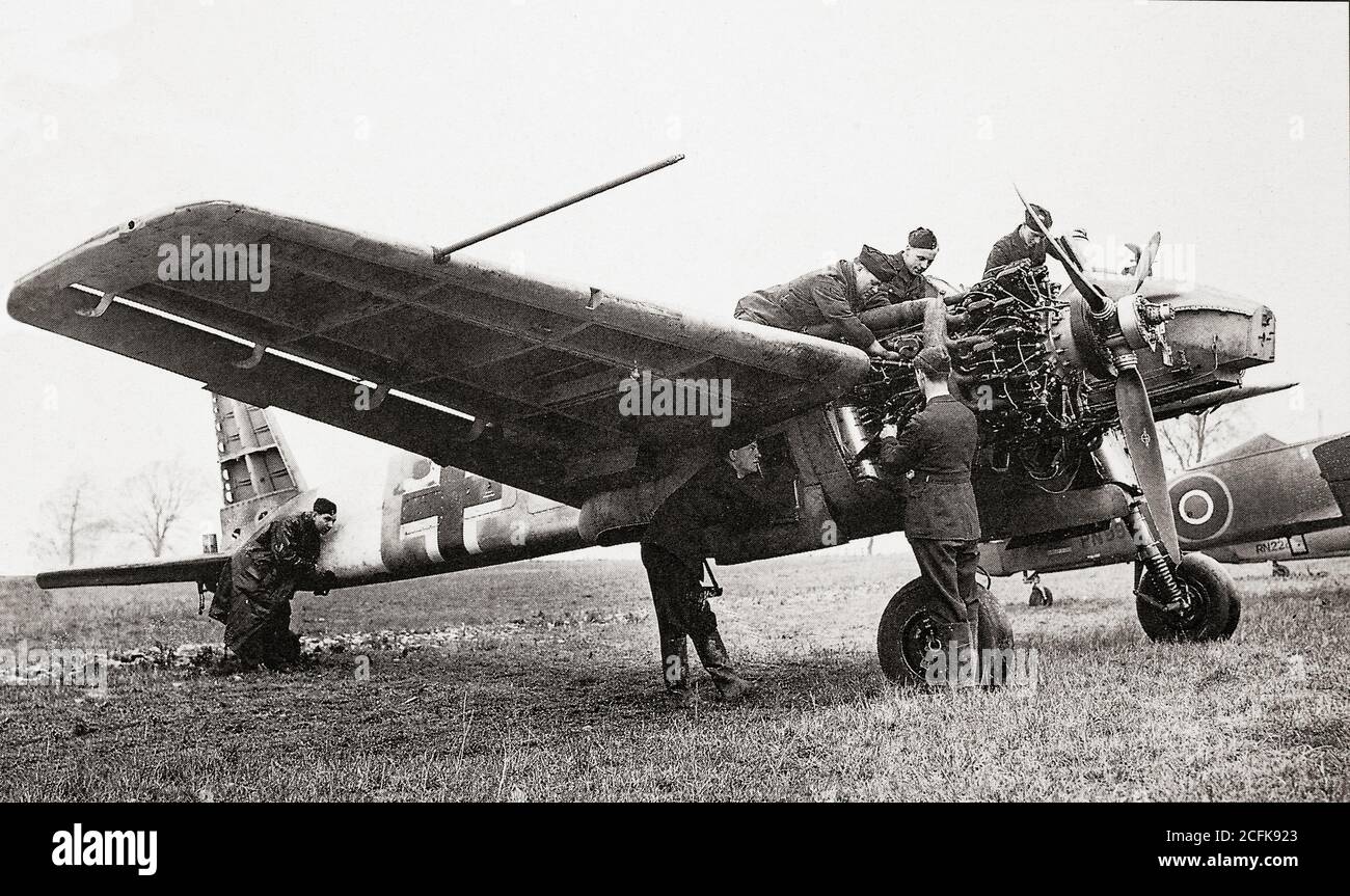 A Henschel Hs 129 ground-attack aircraft of the German Luftwaffe. being examined by members of No. 1426 (Enemy Aircraft) Flight RAF, nicknamed 'the Rafwaffe'. The Royal Air Force flight was formed during the Second World War to evaluate captured enemy aircraft and demonstrate their characteristics to other Allied units. Stock Photo