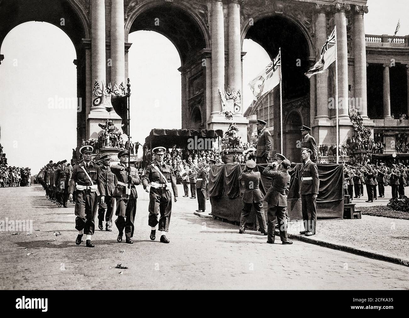 July 1945, Air Marshal Sir Arthur Coningham and the Burgomaster of Brussels take the salute during a march past through the Triumphal Arch by the RAF shortly before they leave Belgium. Stock Photo