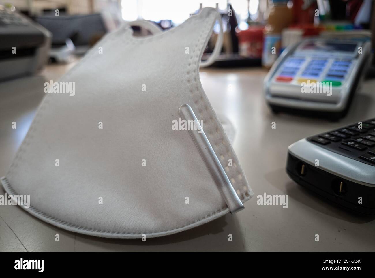 Face mask or face covering on the sales counter of a high street