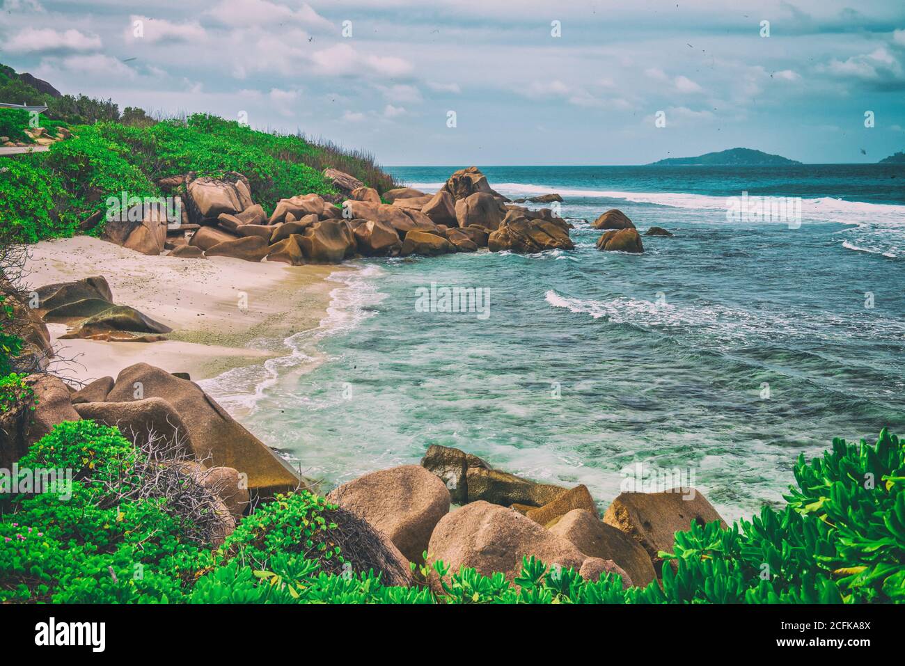 Amazing picturesque paradise beach with granite rocks, white sand and palm trees on a tropical landscape, Seychelles. Stock Photo