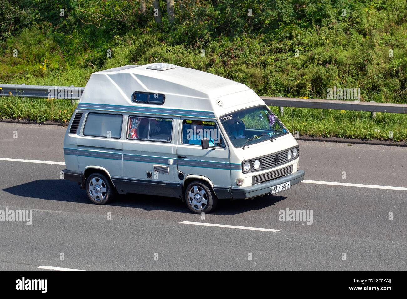 1983 80s WHITE vw Volkswagen HIGH-TOP VAN; Caravans and Motorhomes, campervans on Britain's roads, RV leisure vehicle, family holidays, caravanette vacations, Touring caravan holiday, van conversions, Vanagon autohome, life on the road, Stock Photo