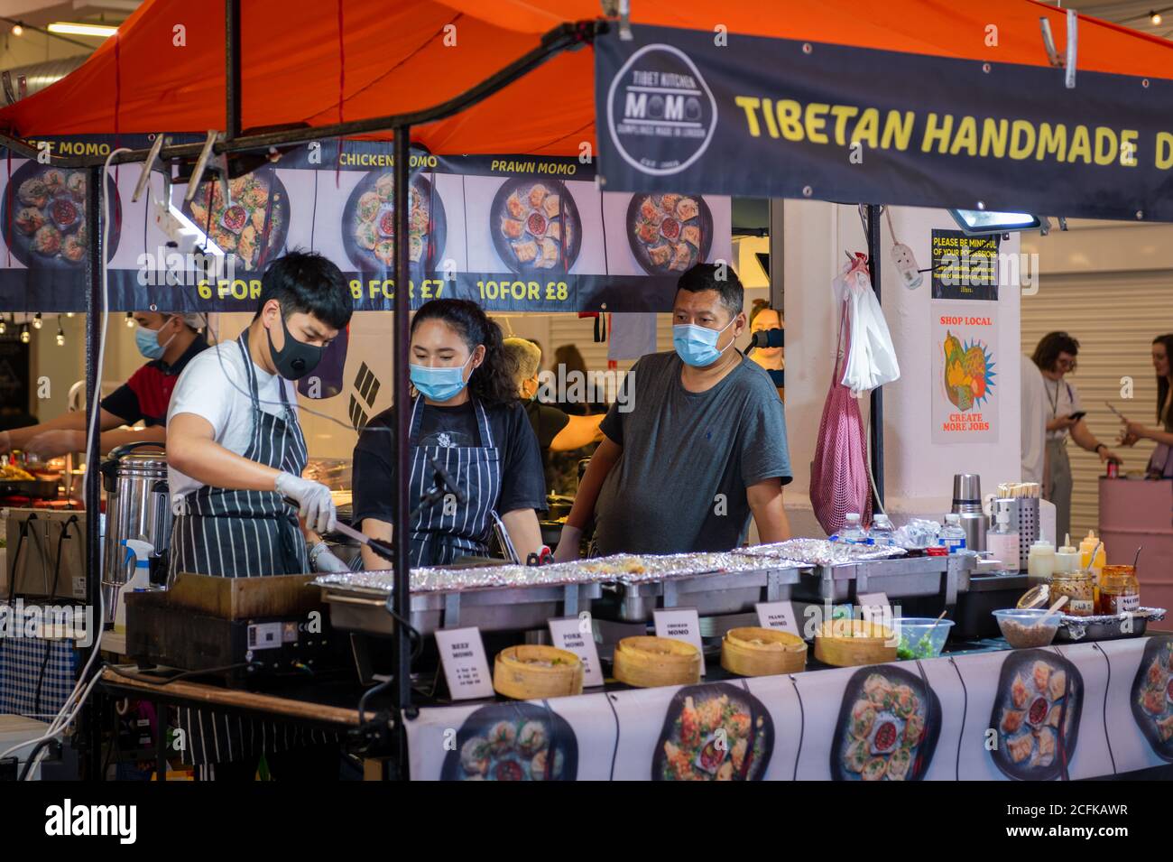 A food stall in the indoor market on Brick Lane offering hand made Tibetan dumplings. Stock Photo