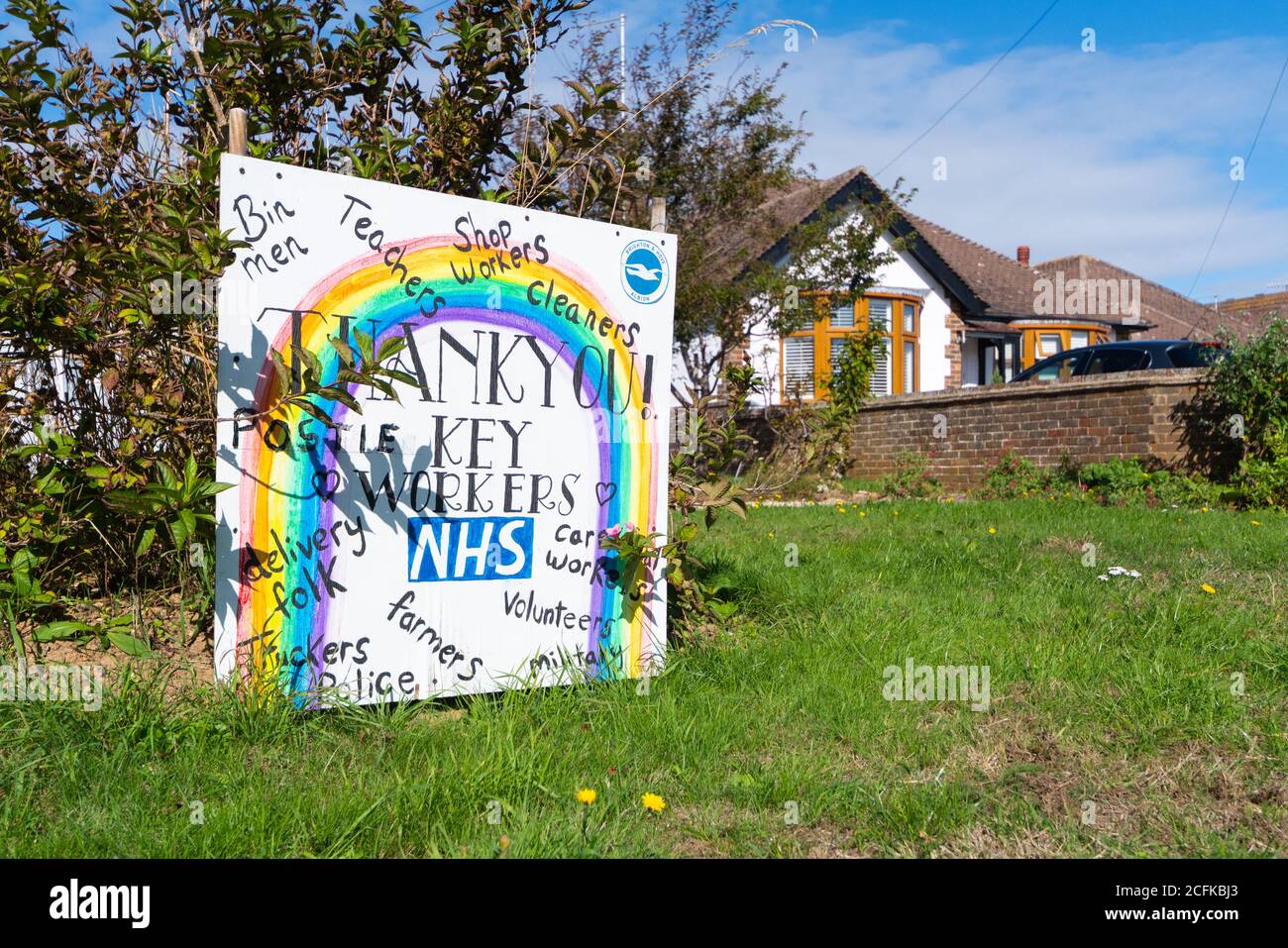 Home made thank you sign on a green, thanking NHS staff & key workers for efforts during COVID-19 Coronavirus pandemic, in West Sussex, England, UK. Stock Photo