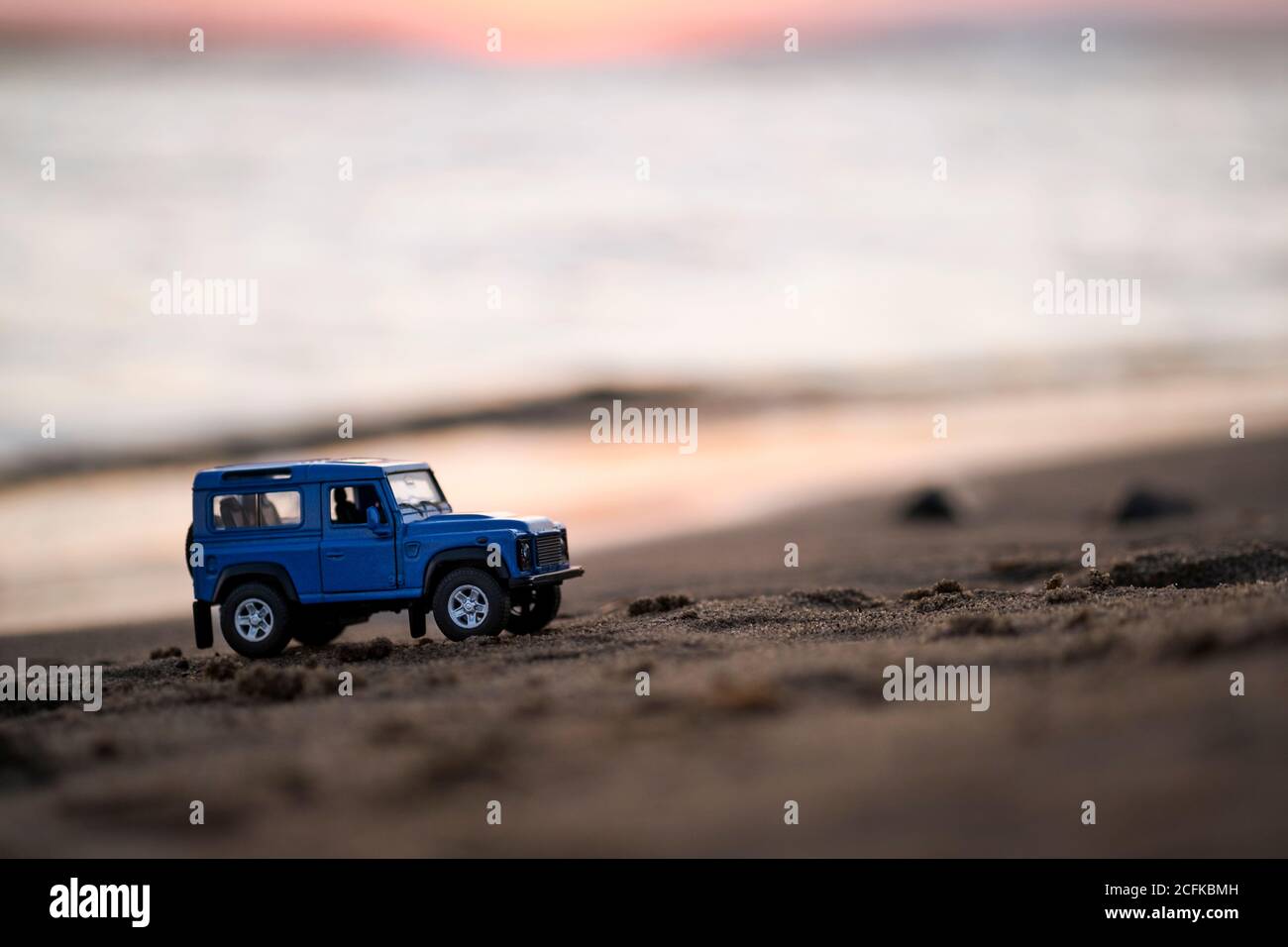 Izmir, Turkey - August 22, 2020: Close up shot of a Land Rover SUV vehicle on sand and on sunset. Stock Photo