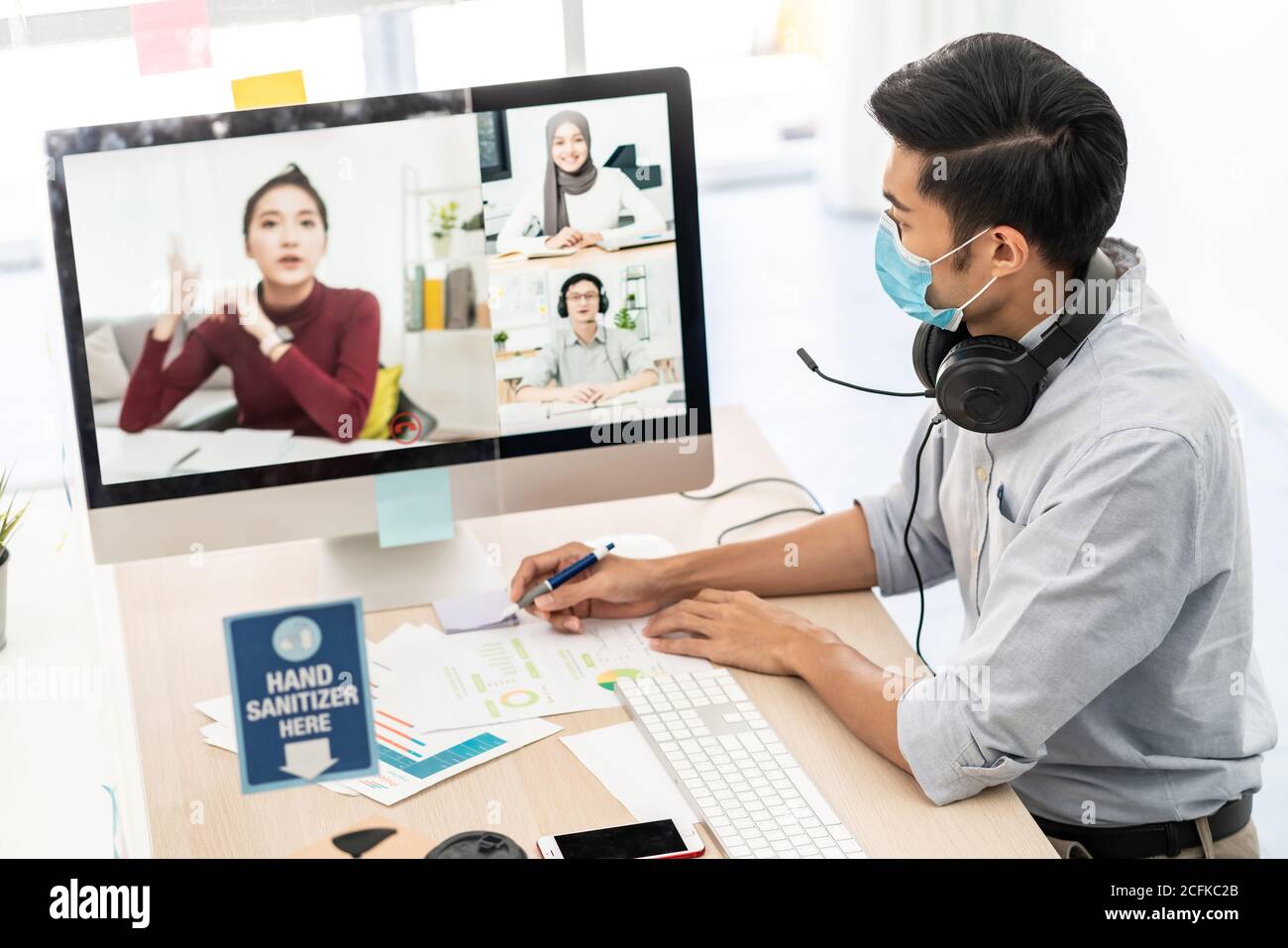 Asian businessman work from home office involved video conference meeting with corporate colleague for discuss and brainstorm distantly. This technolo Stock Photo