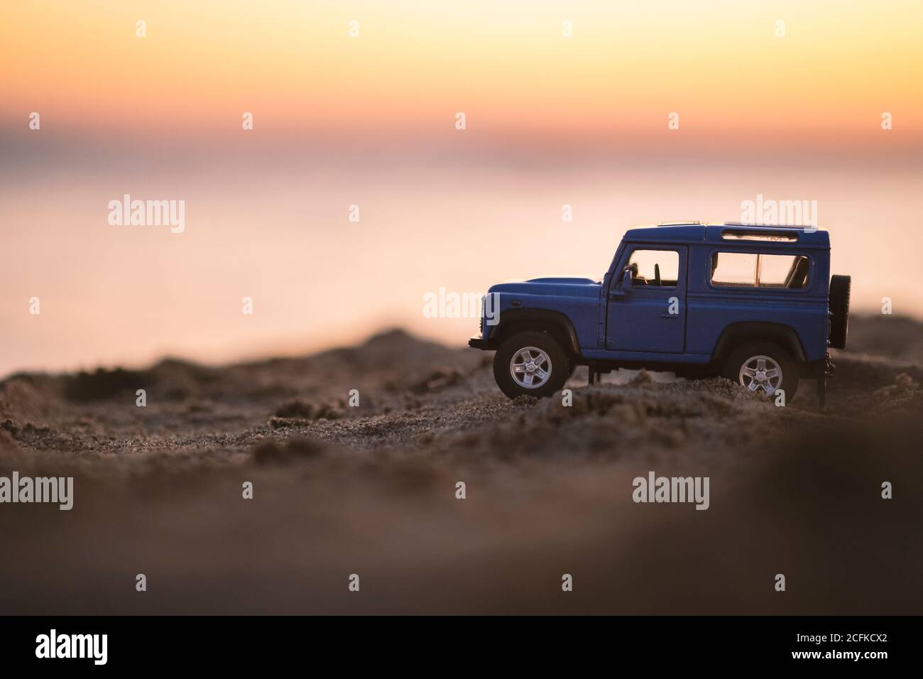 Izmir, Turkey - August 22, 2020: Close up shot of a Land Rover SUV vehicle on sand and on sunset. Stock Photo