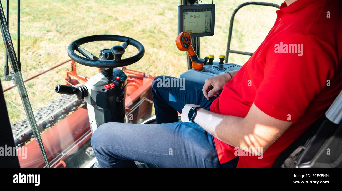 Unmanned autonomous harvester on the field. View from the cockpit. The