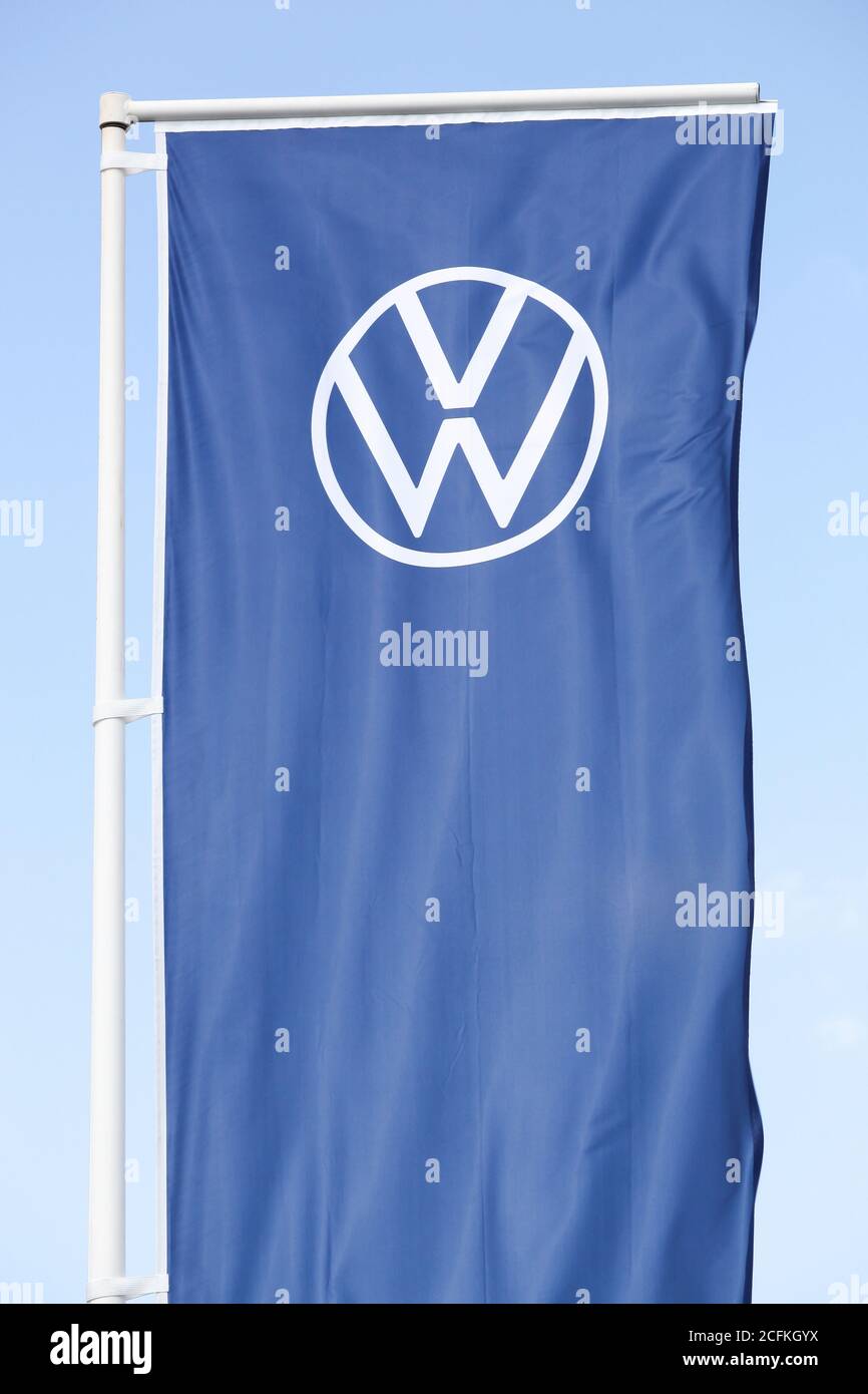 Belleville, France - August 23, 2020: New Volkswagen logo on a flag. Volkswagen is a German car manufacturer headquartered in Wolfsburg, Germany Stock Photo