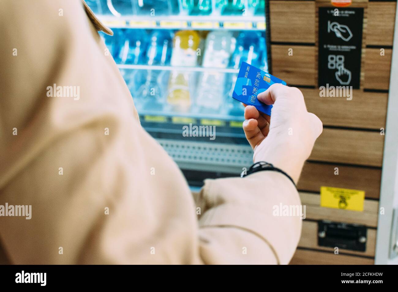 close-up of a woman using her credit card to pay at the vending machine Stock Photo