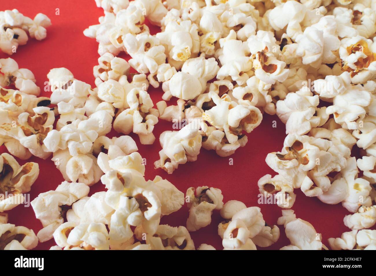Close up popcorn on color red background Stock Photo