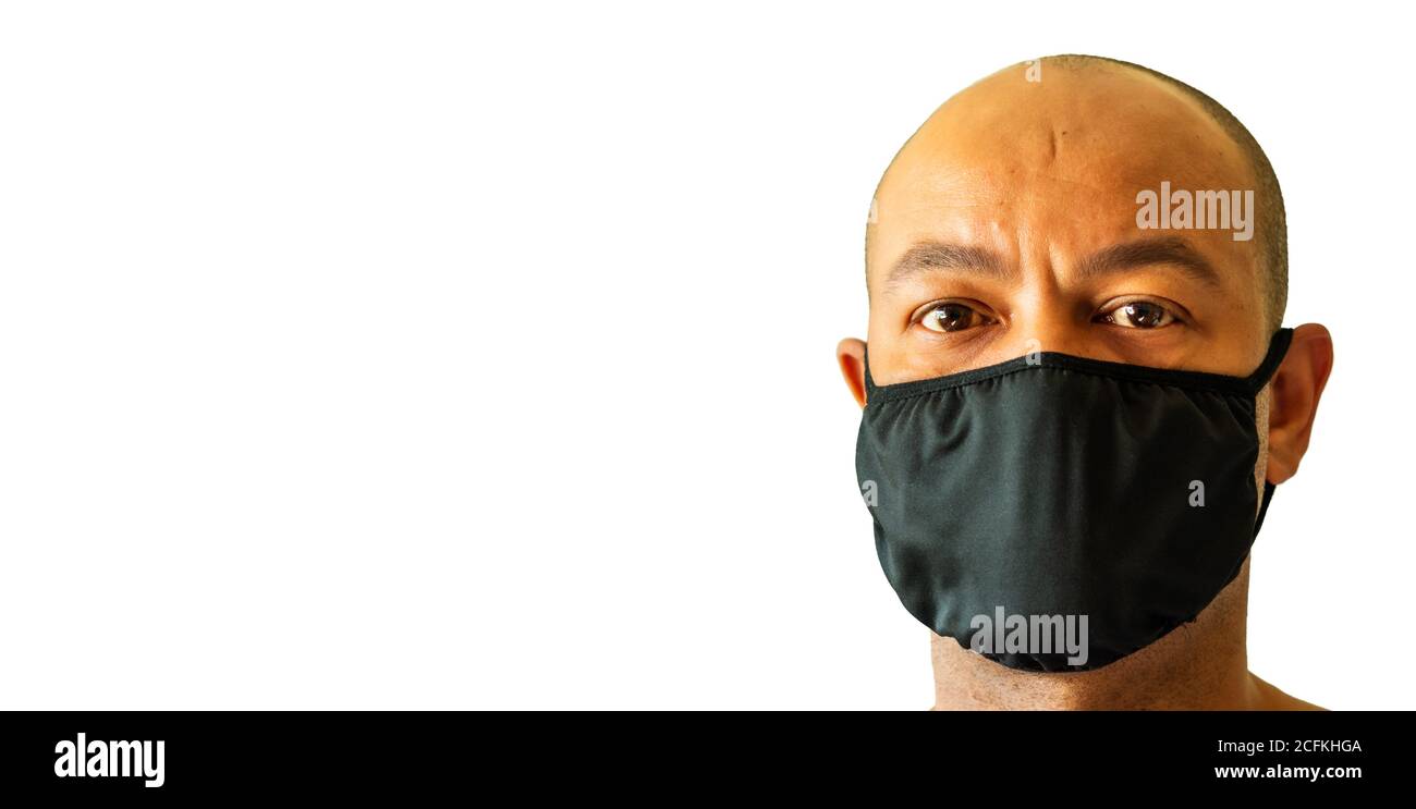 Head shot of a black man wearing a face mask over his nose and mouth. Public health concept. Stock Photo