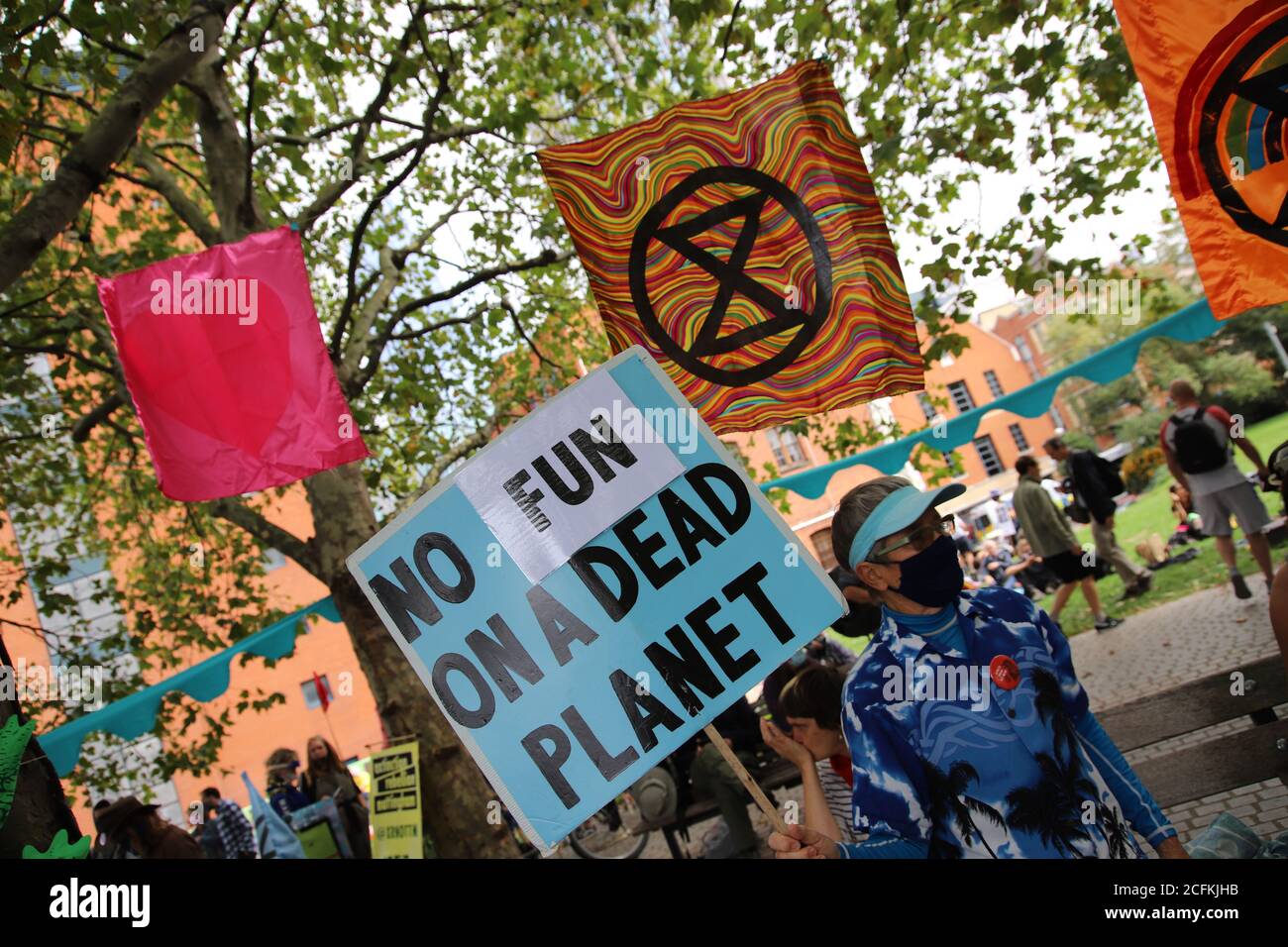 London, UK. 06th Sep, 2020. Extinction Rebellion hold a Flood Alert beach party to highlight the threat of rising tides and the risk of widespread flooding at Oxo Tower Wharf, London, 6th September 2020. Flags with XR symbols hang on the trees and a protestor holds a banner saying no fun on a dead planet Credit: Denise Laura Baker/Alamy Live News Stock Photo