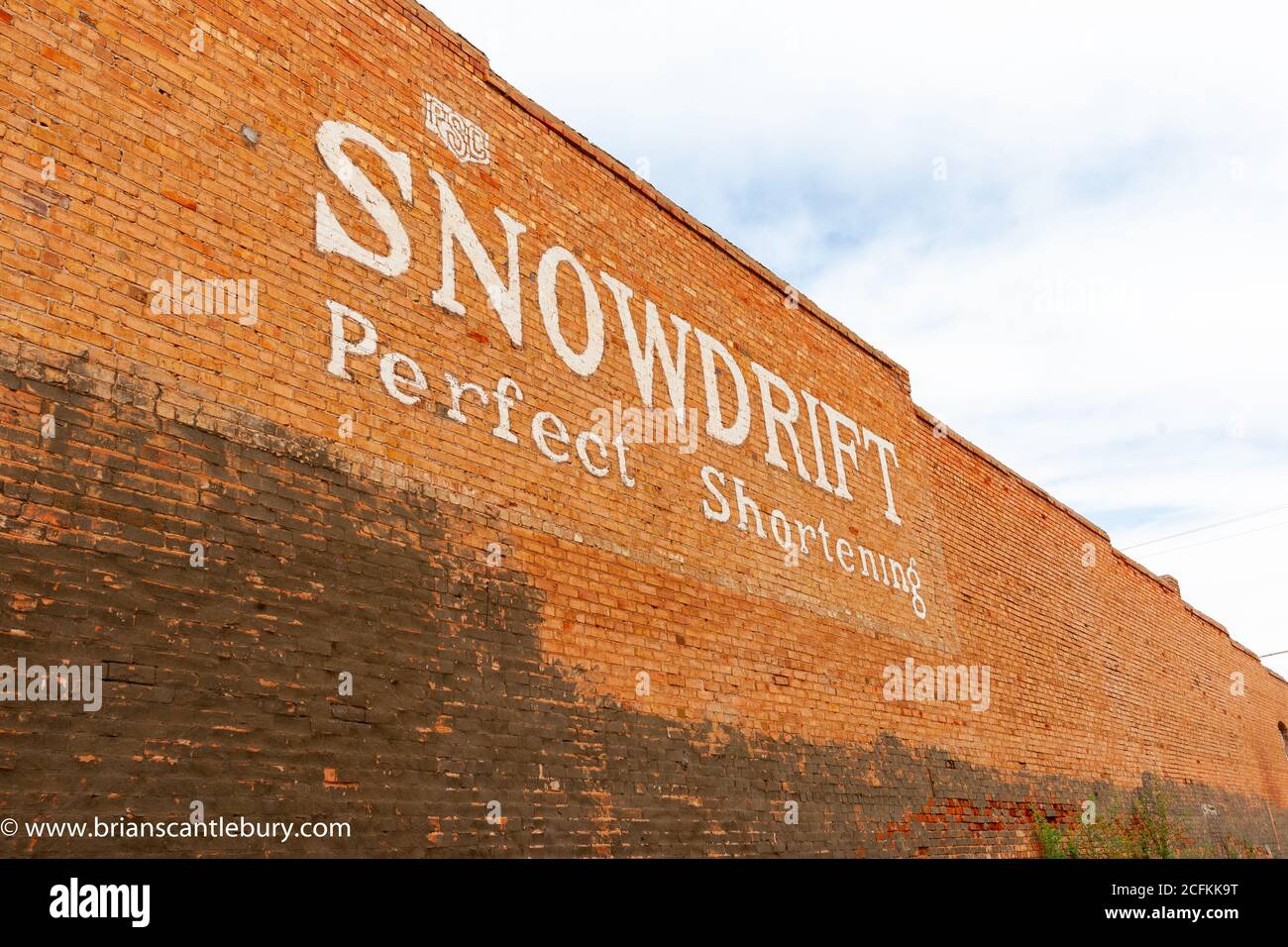 Winslow Arizona USA - September 22 2015; Traditional American cooking product brand sign in white lettering on orange brick wall. Stock Photo