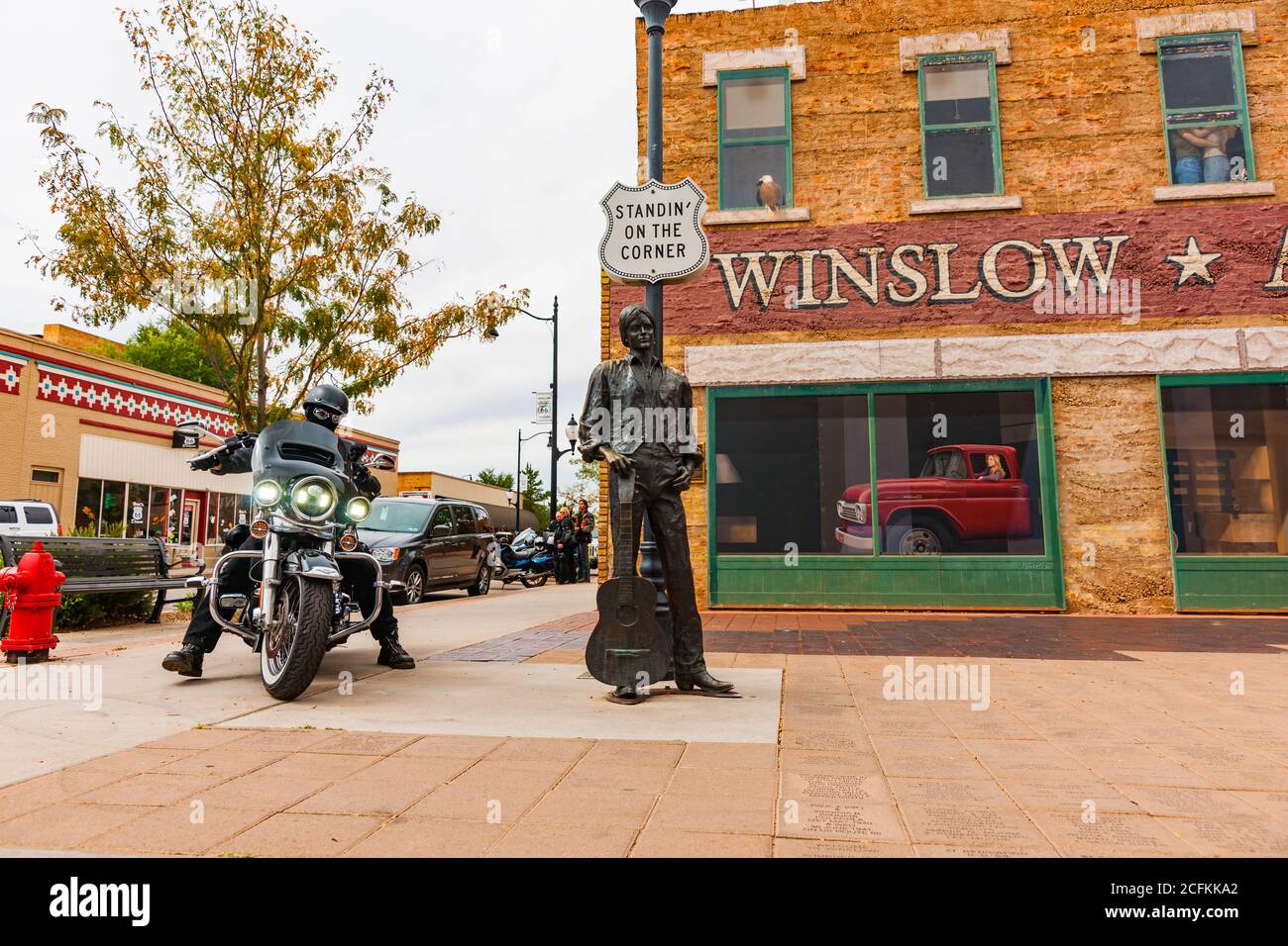 Winslow Arizona USA - September 22 2015; Tourist arrives on Harley Davidson motorcycle at famous  Winslow Arizona br statue of Eagles band-member Glen Stock Photo