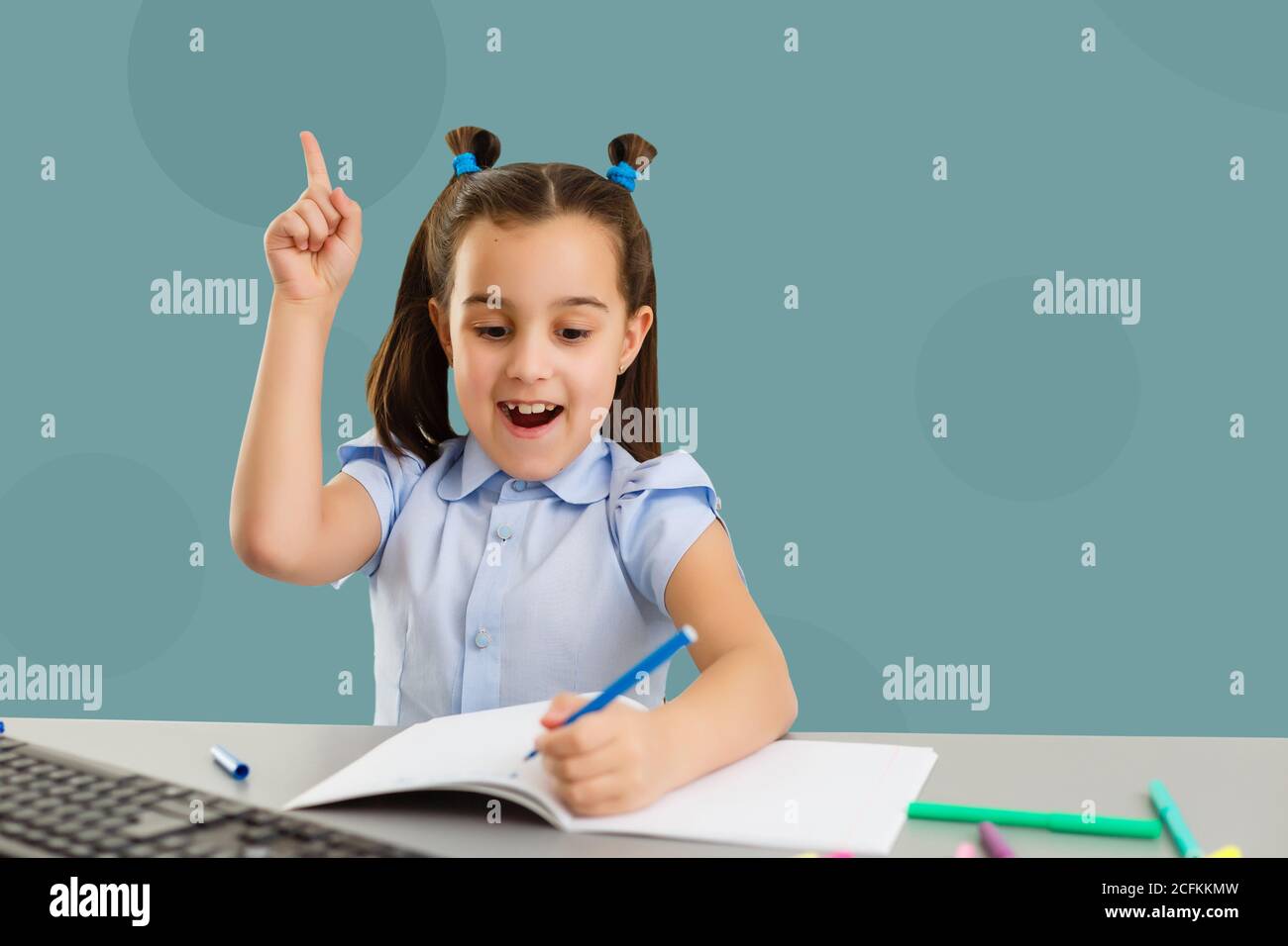 Cute little girl studying at the library and smiling Stock Photo - Alamy