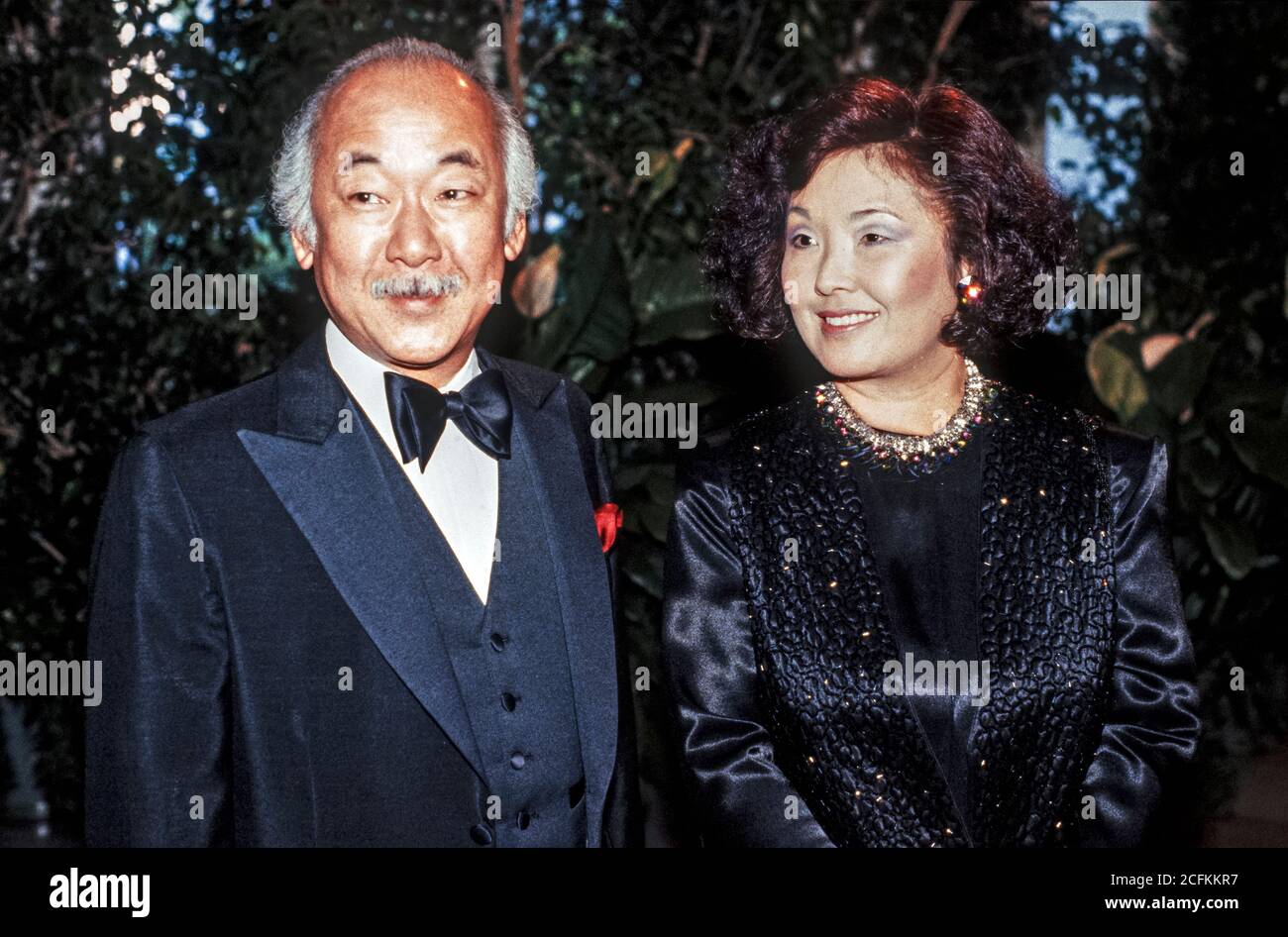American actor Noriyuki 'Pat' Morita and his wife, Yukiye “Yuki” Kitahara, arrive at the White House in Washington, DC for the State Dinner hosted by United States President Ronald Reagan and first lady Nancy Reagan in honor of Prime Minister Yasuhiro Nakasone of Japan on April 30, 1987.Credit: Ron Sachs/CNP | usage worldwide Stock Photo