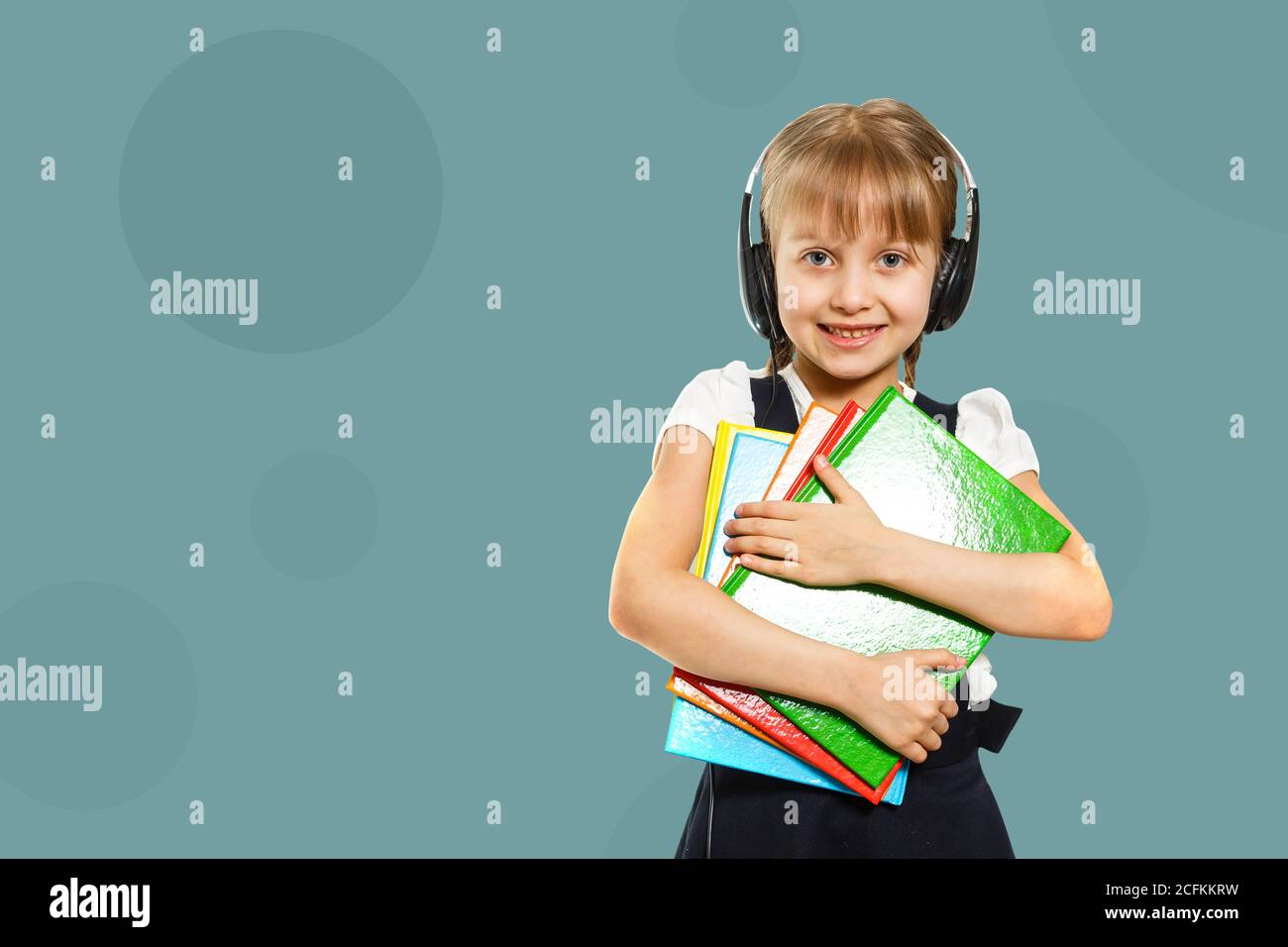 Cute little girl studying at the library and smiling Stock Photo - Alamy