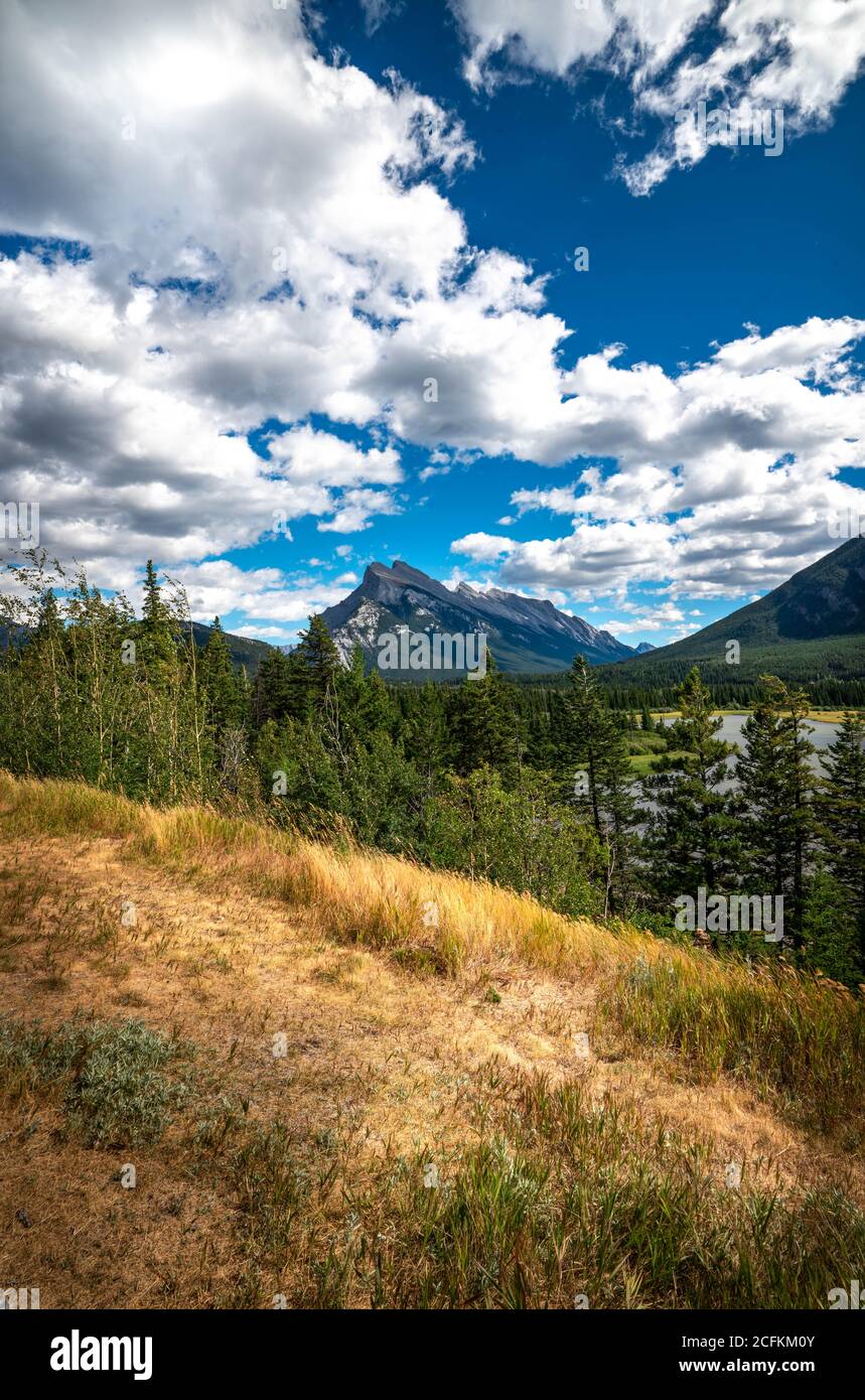 Mount Rundle with bright blue sky and dramatic clouds. Stock Photo