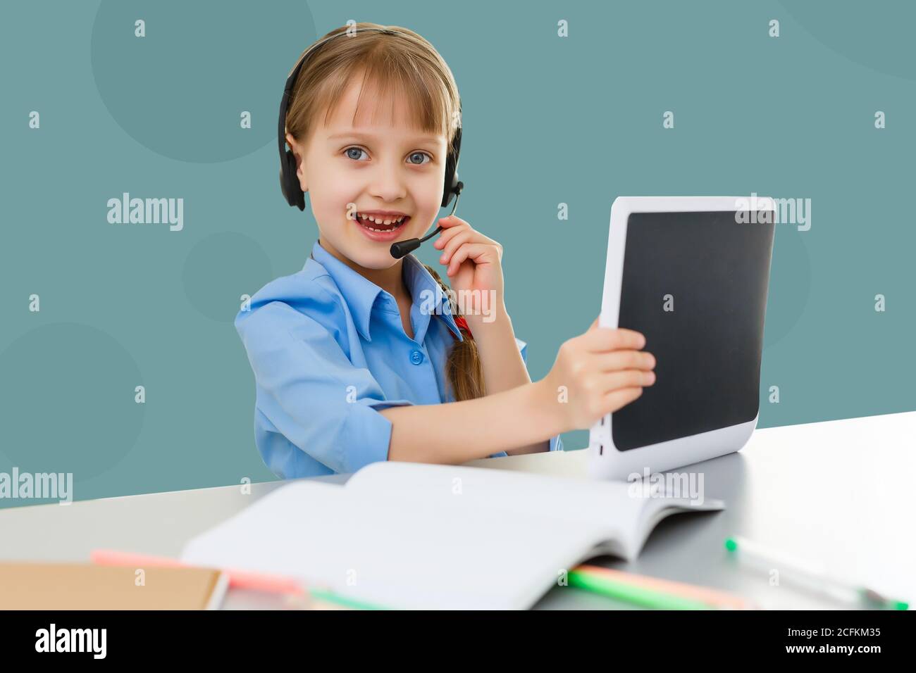 Cute little girl studying at the library and smiling Stock Photo - Alamy