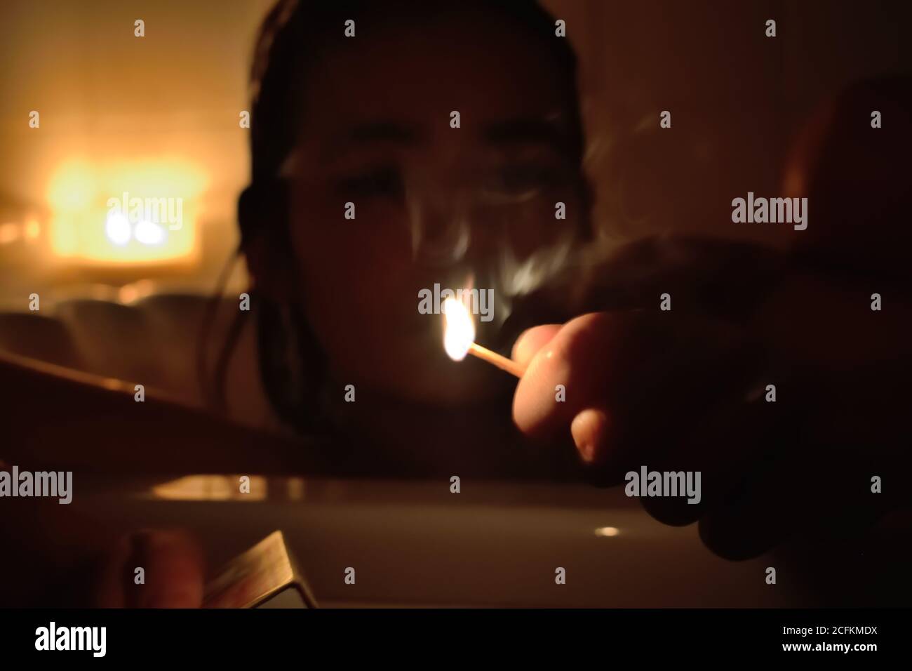 Person Lighting a Match in a Bathtub Stock Photo Alamy