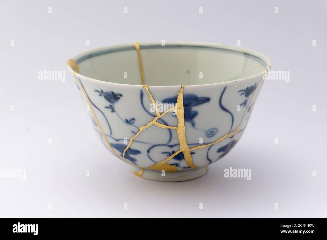 Kintsugi tea bowl ceremony chawan. Gold cracks restoration on old