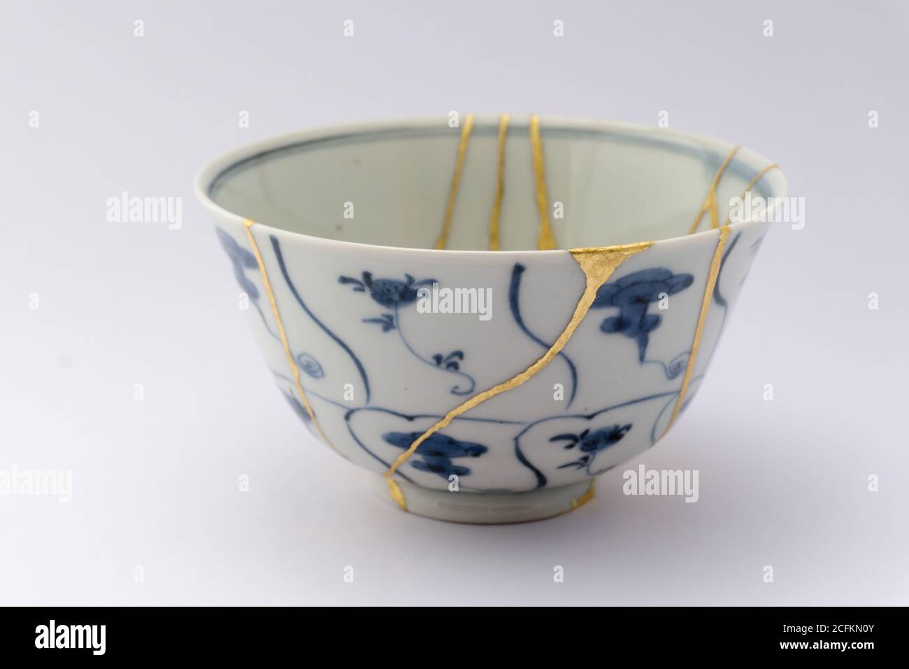 Kintsugi tea bowl ceremony chawan. Gold cracks restoration on old
