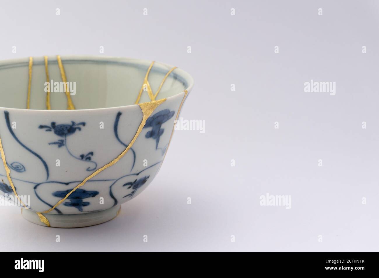 Kintsugi tea bowl ceremony chawan. Gold cracks restoration on old