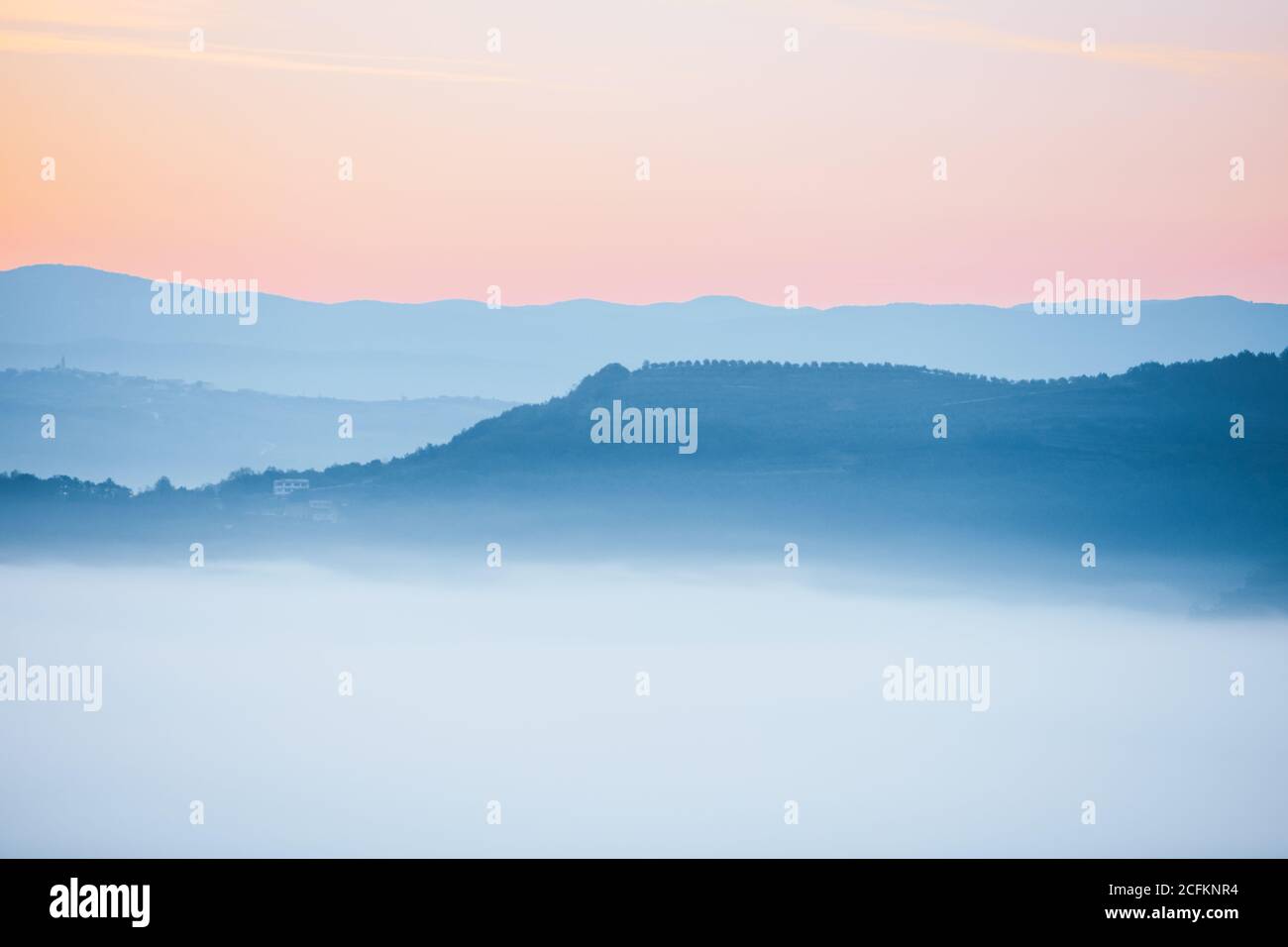 view of sunrise over the mountains mist and clouds under peaks Stock ...