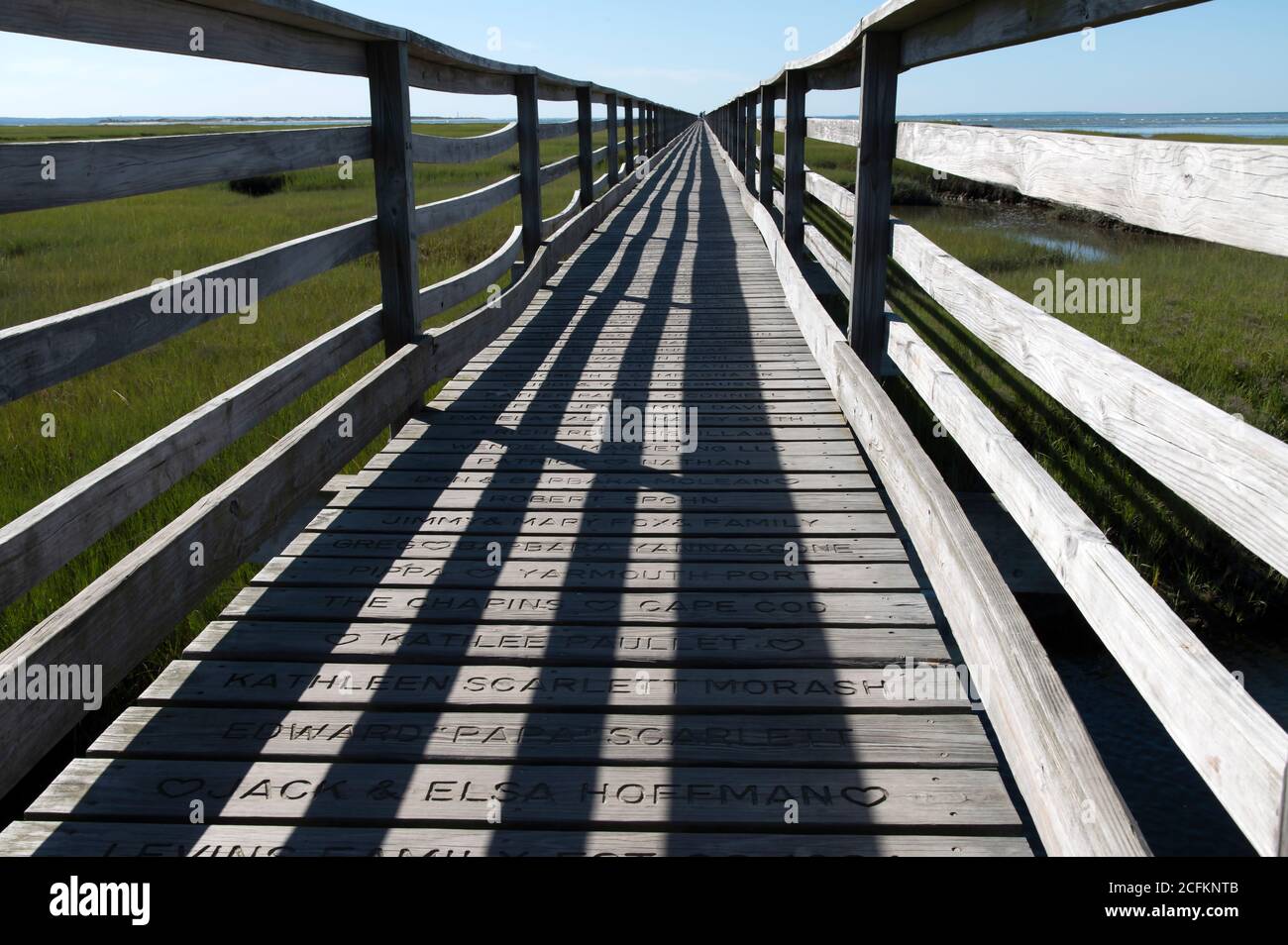 Shadows play a role in design at a Cape Cod boardwalk. Stock Photo