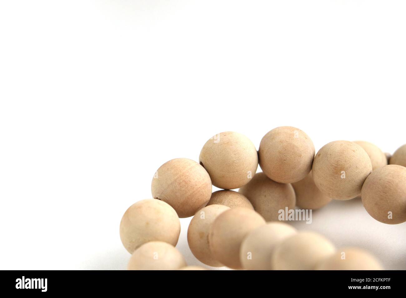 A beautiful string of wooden beads isolated on a white background Stock Photo