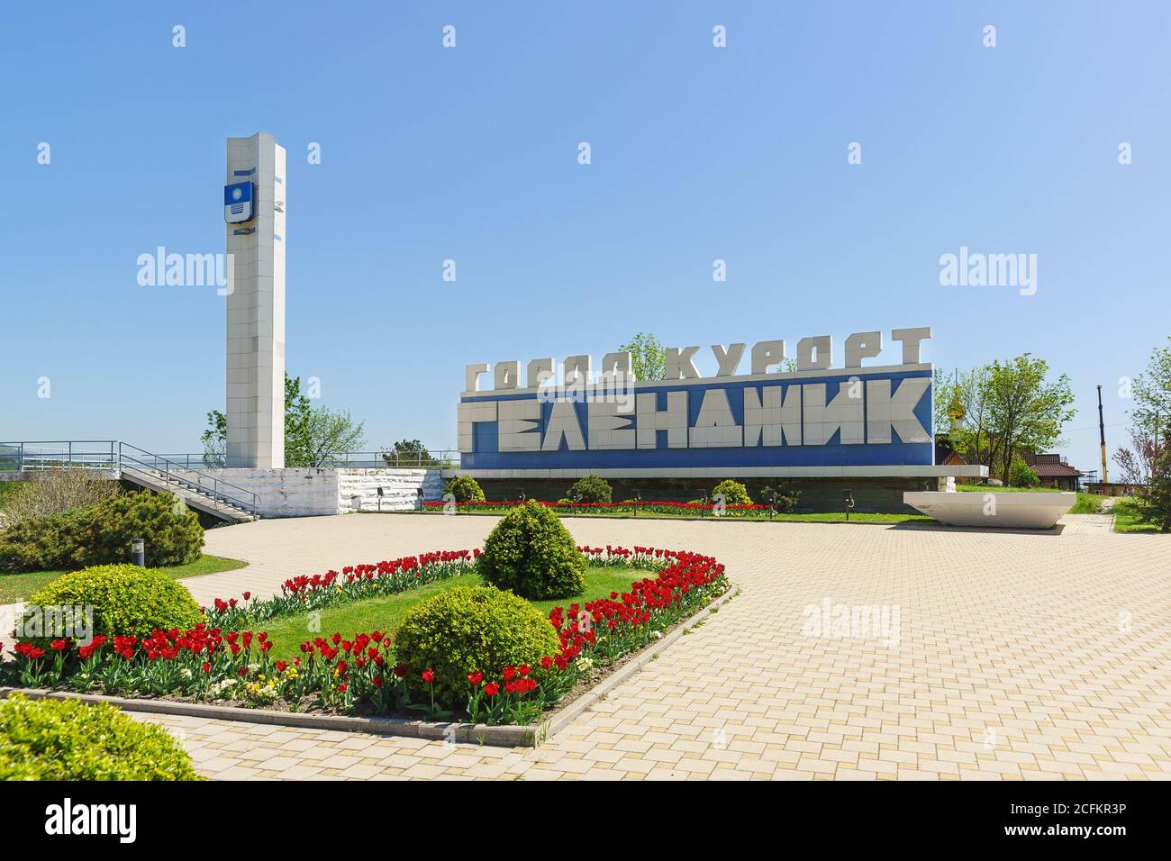 Gelendzhik, Krasnodar Krai, Russia - April 29.2017: Stele with the inscription 'hero City of Gelendzhik' and spring flowerbed with red tulips at the e Stock Photo